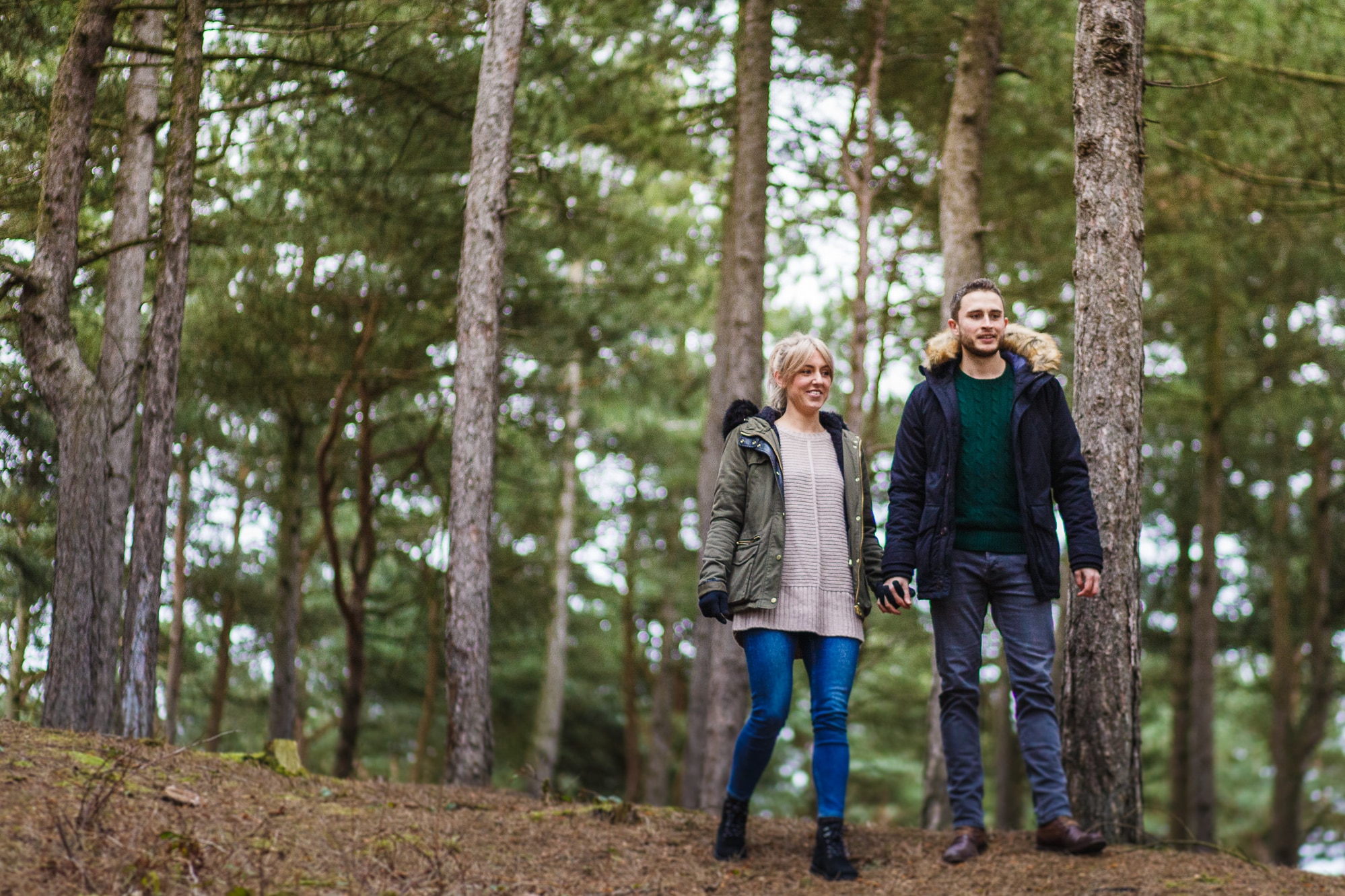 Couple standing looking in Formby Woods