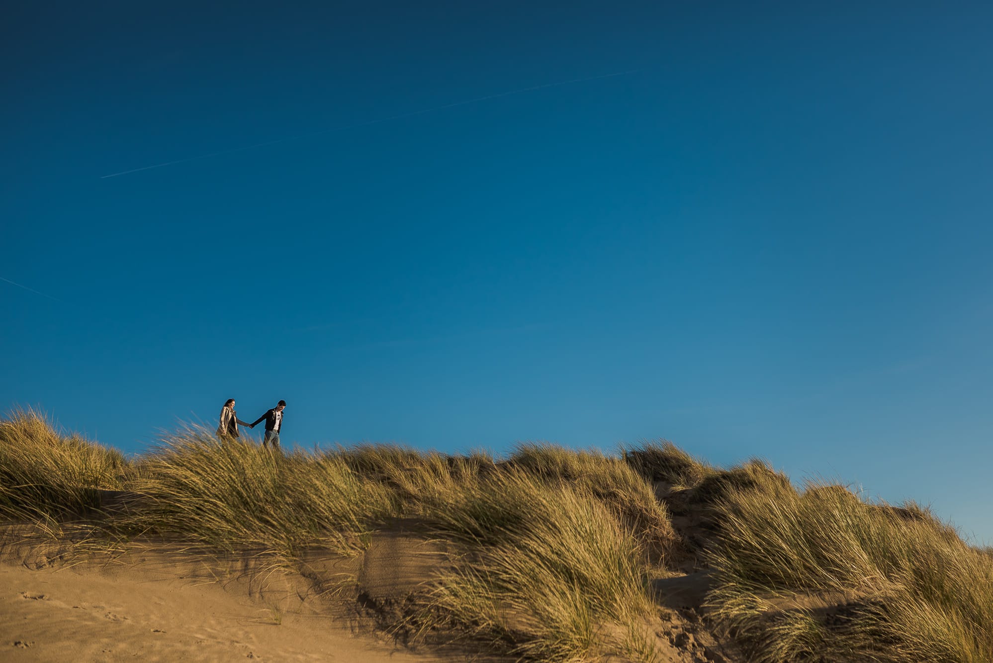 couple on top of sand dunes