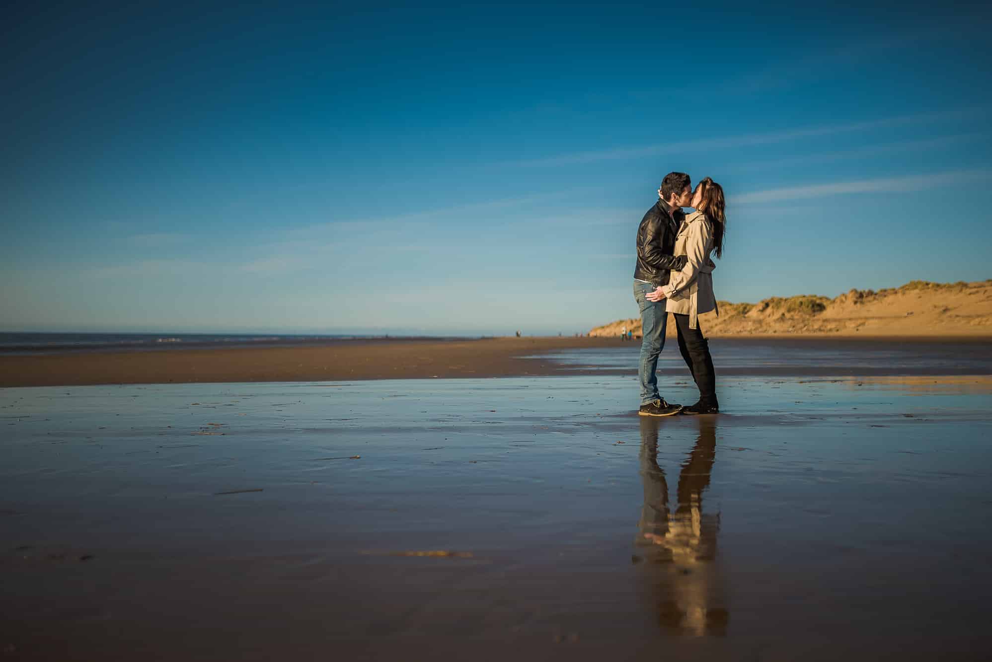 Couple cuddling on beach
