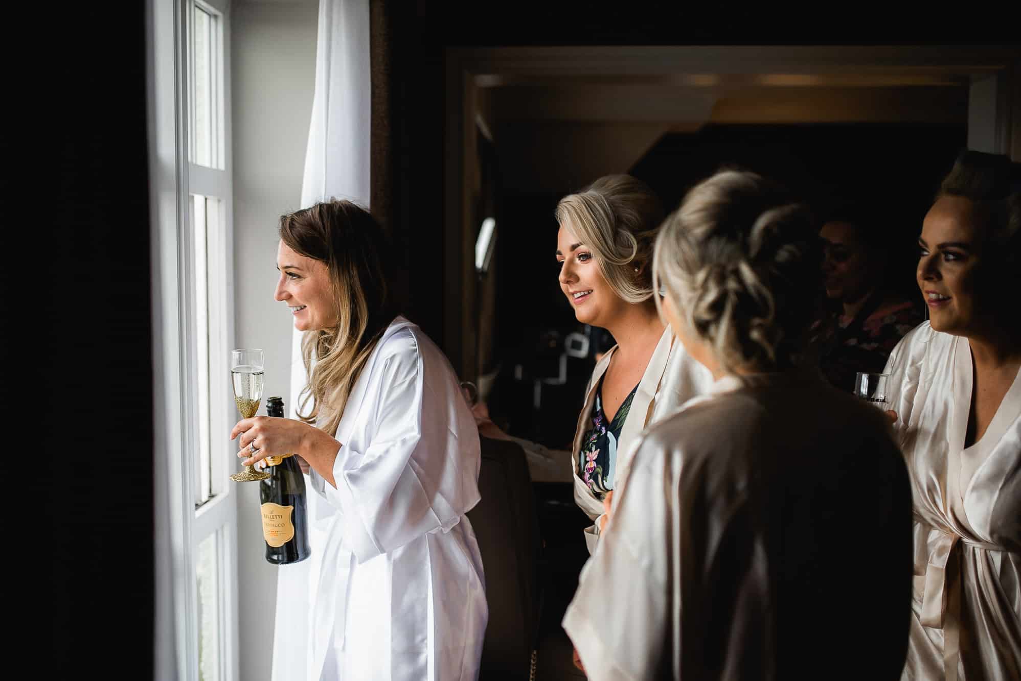 Bride looking out on the men playing golf
