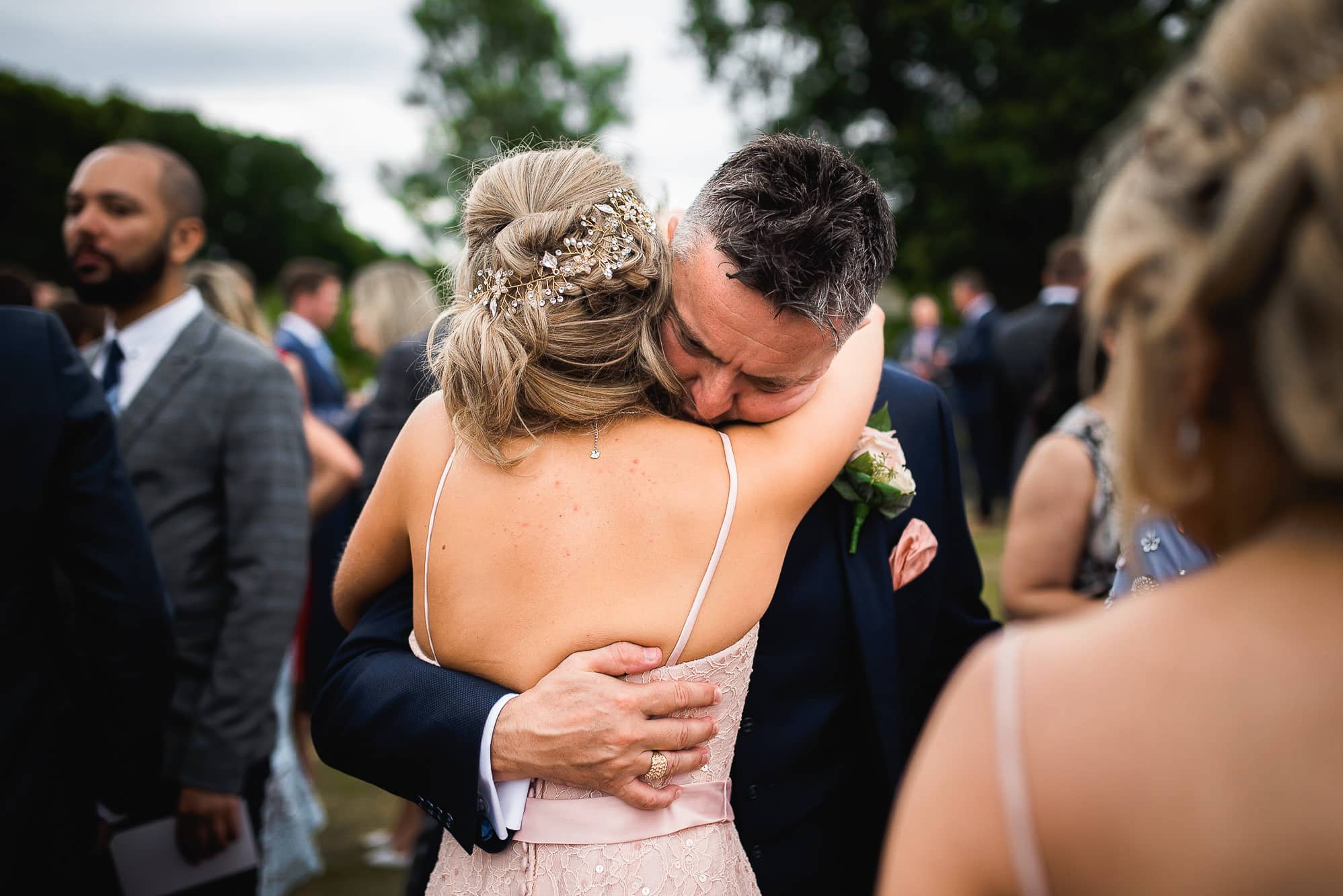 Dad hugging bridesmaid