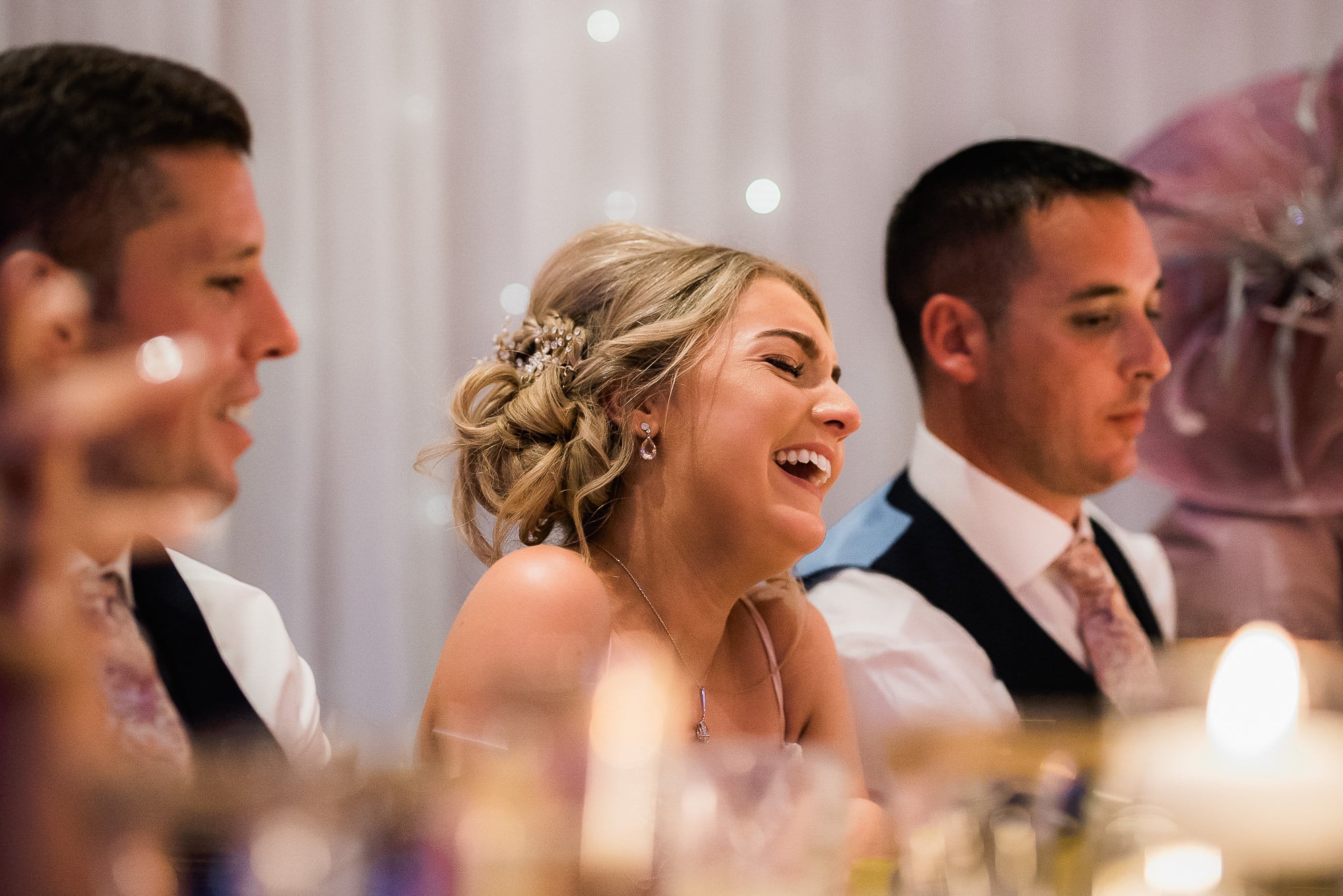 Bridesmaid laughing during speeches