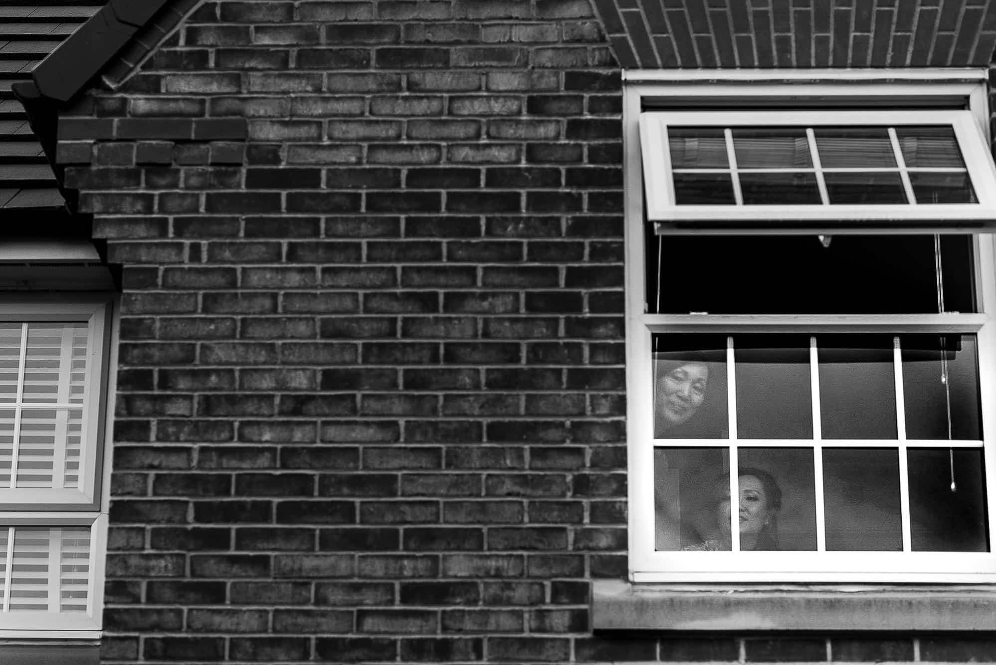 Chinese Wedding Photography | Manchester | Ray & Julie 9 Bride looking on from window