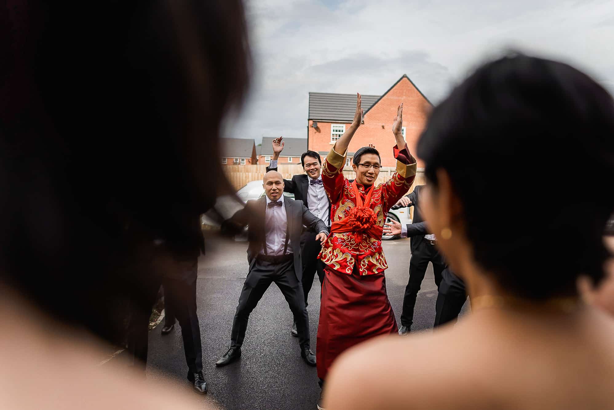 Chinese Wedding Photography | Manchester | Ray & Julie 12 Groom dancing for Chinese door game