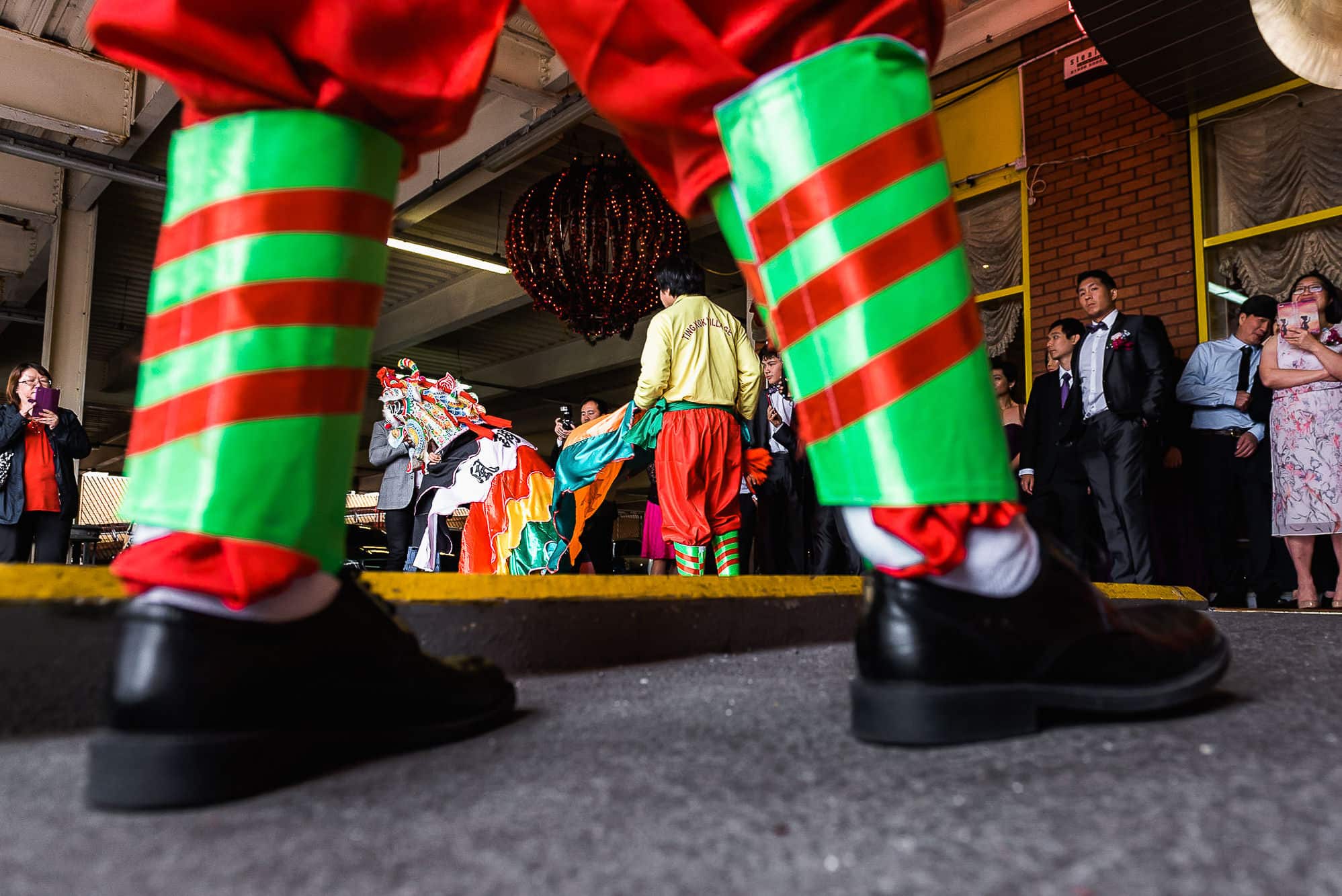 Chinese Wedding Photography | Manchester | Ray & Julie 34 Looking through the legs at Unicorn Dance