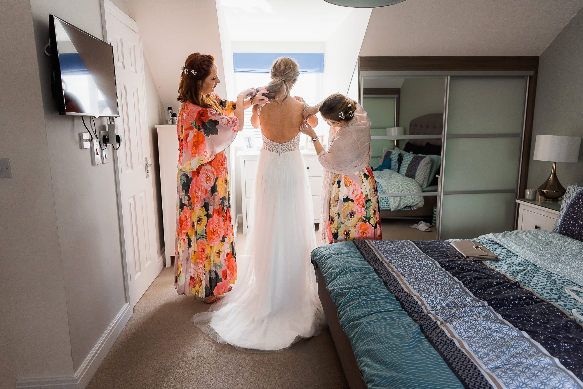 bride putting on her alternative wedding dress
