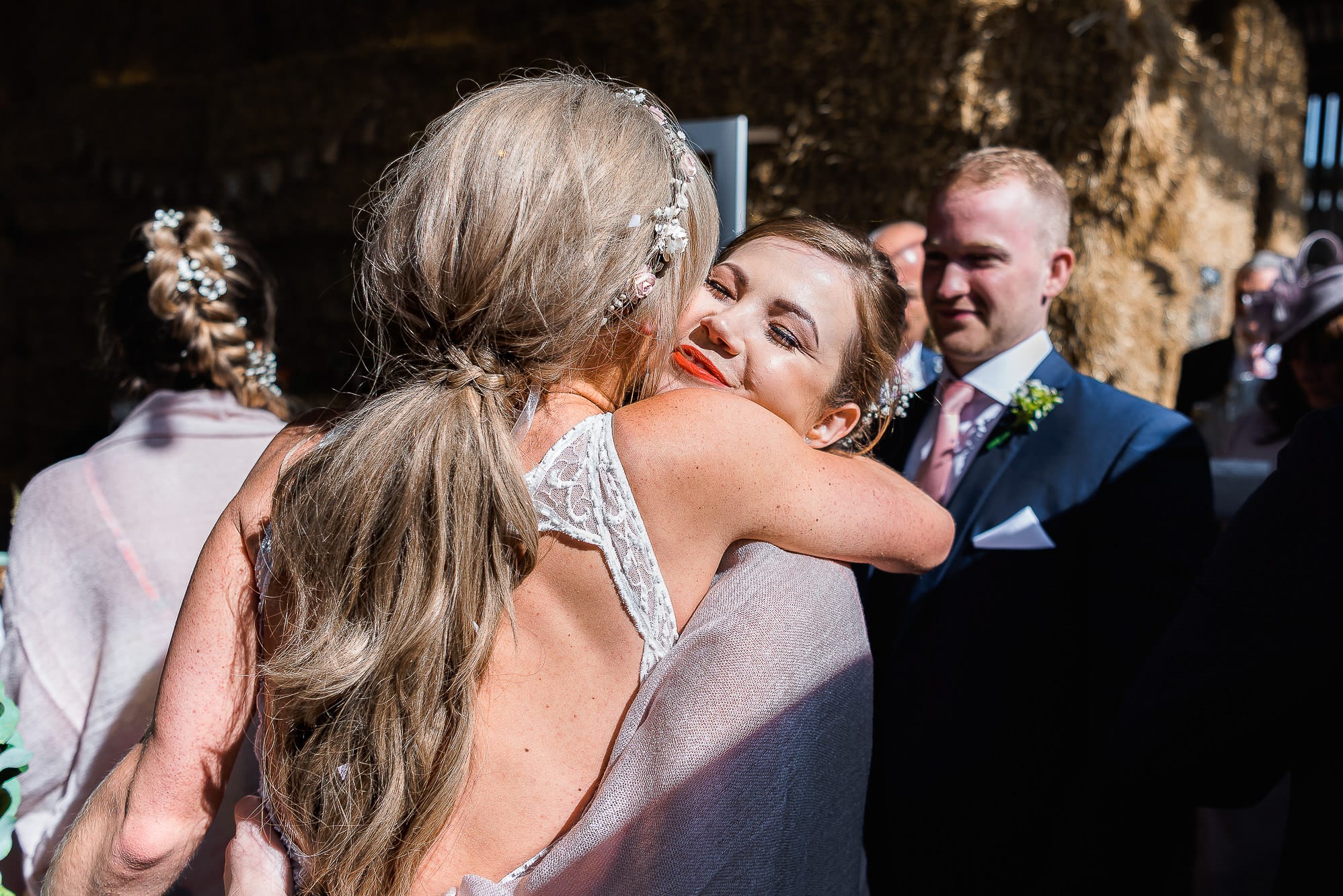bride and bridesmaid hugging