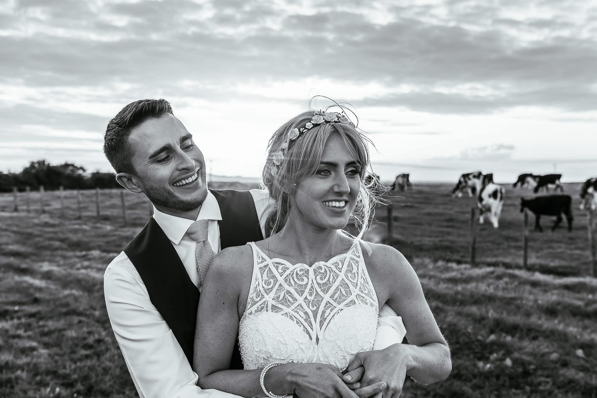 bride and groom cuddling and laughing