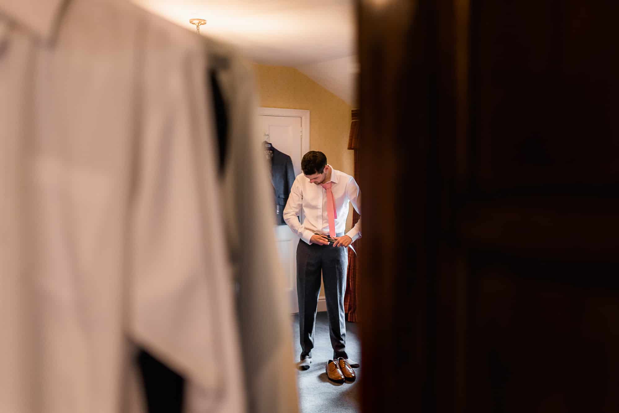 Reflection of groom in mirror