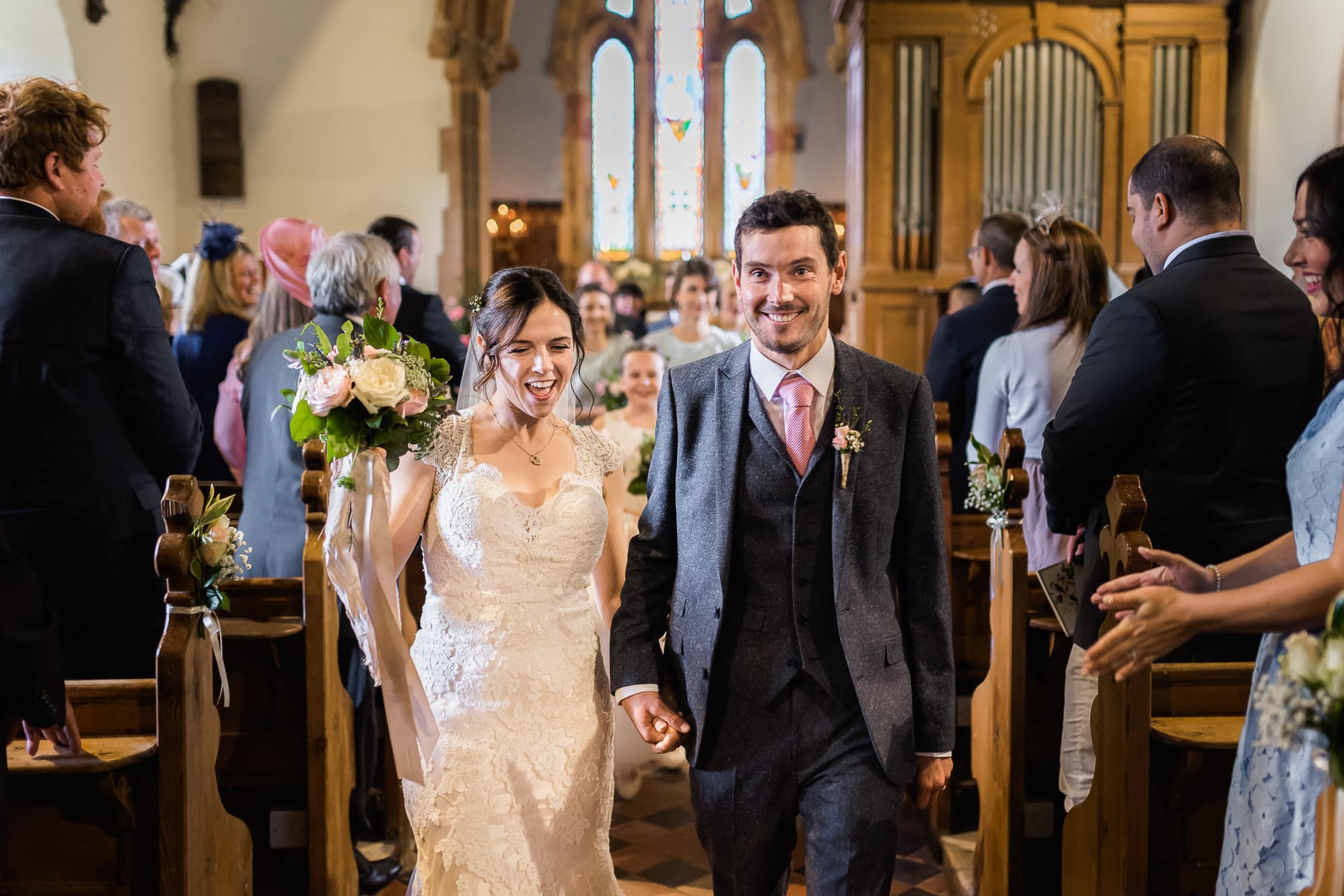 Bride and groom walking out of church