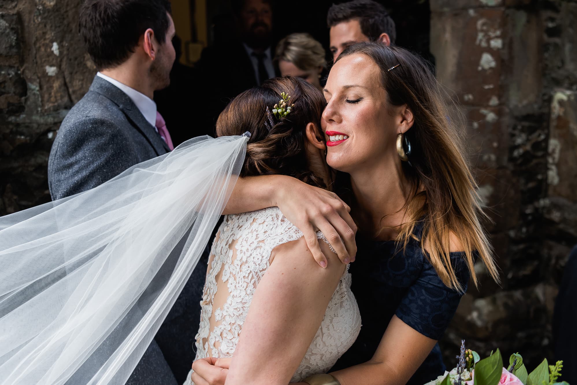Guest hugging bride outside church
