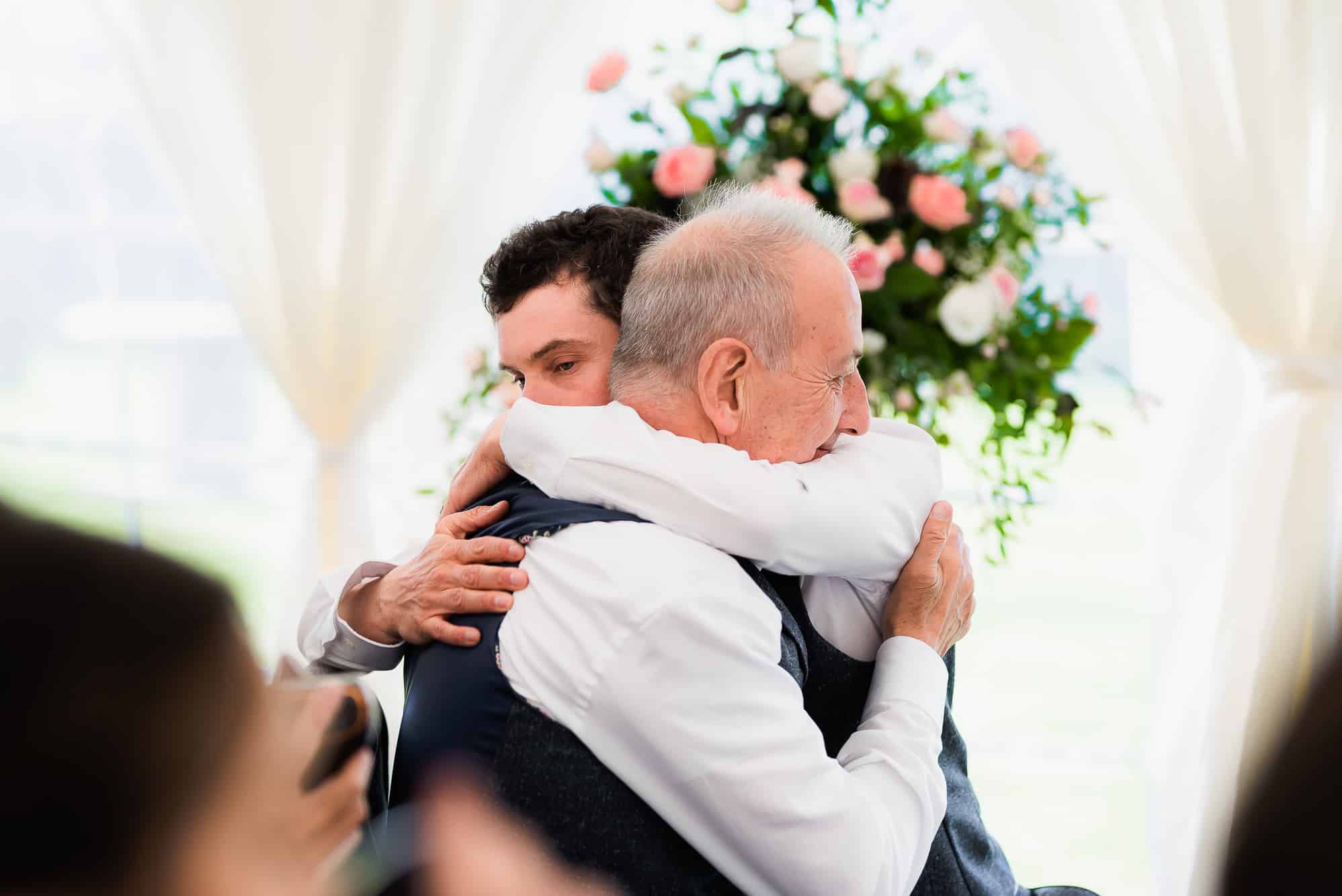 Groom hugging his dad