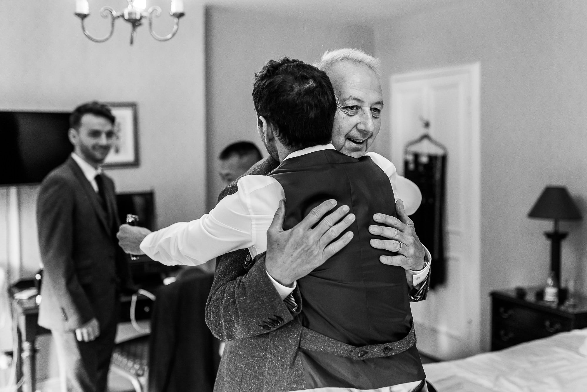 Groom hugging dad