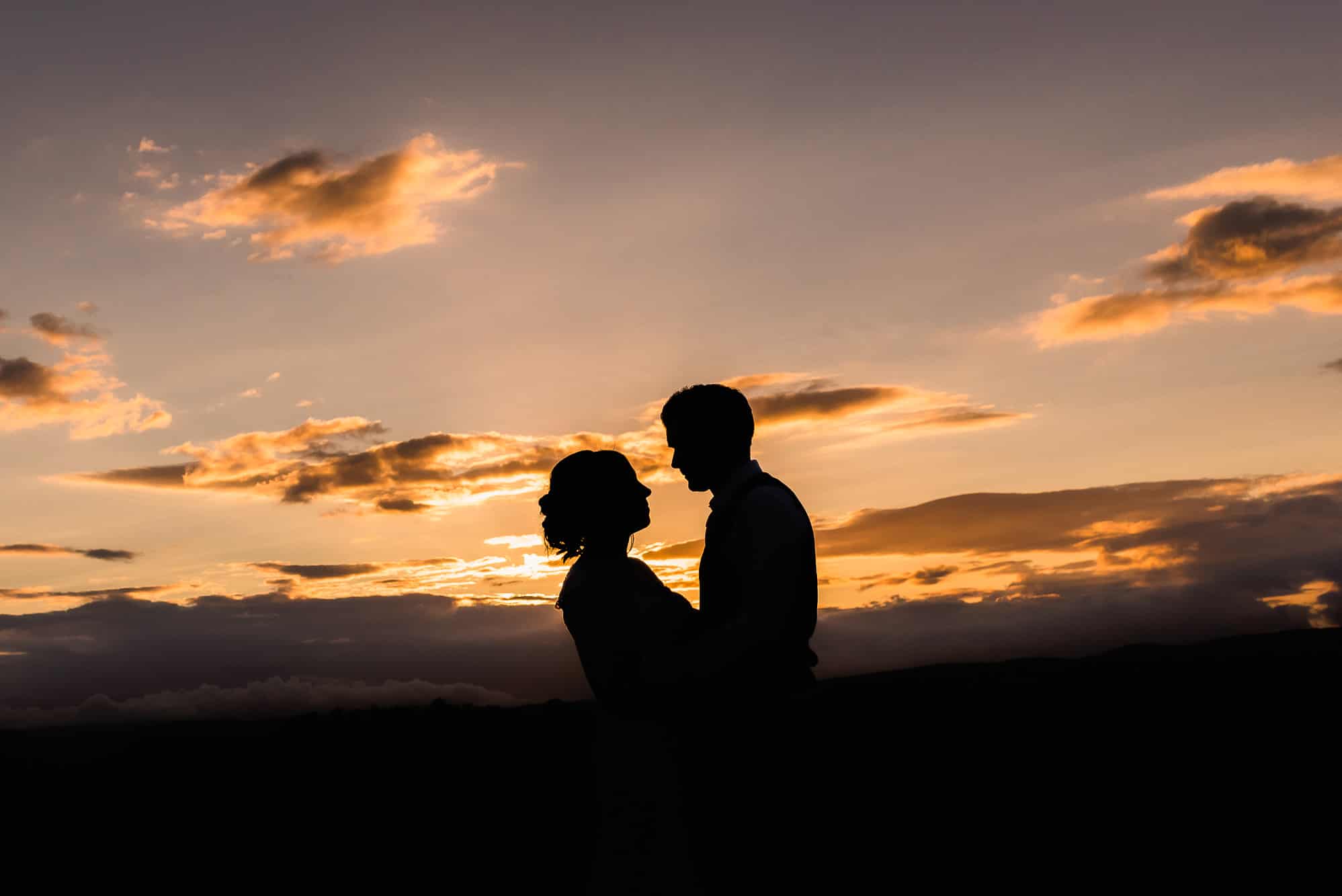 bride and groom at sunset