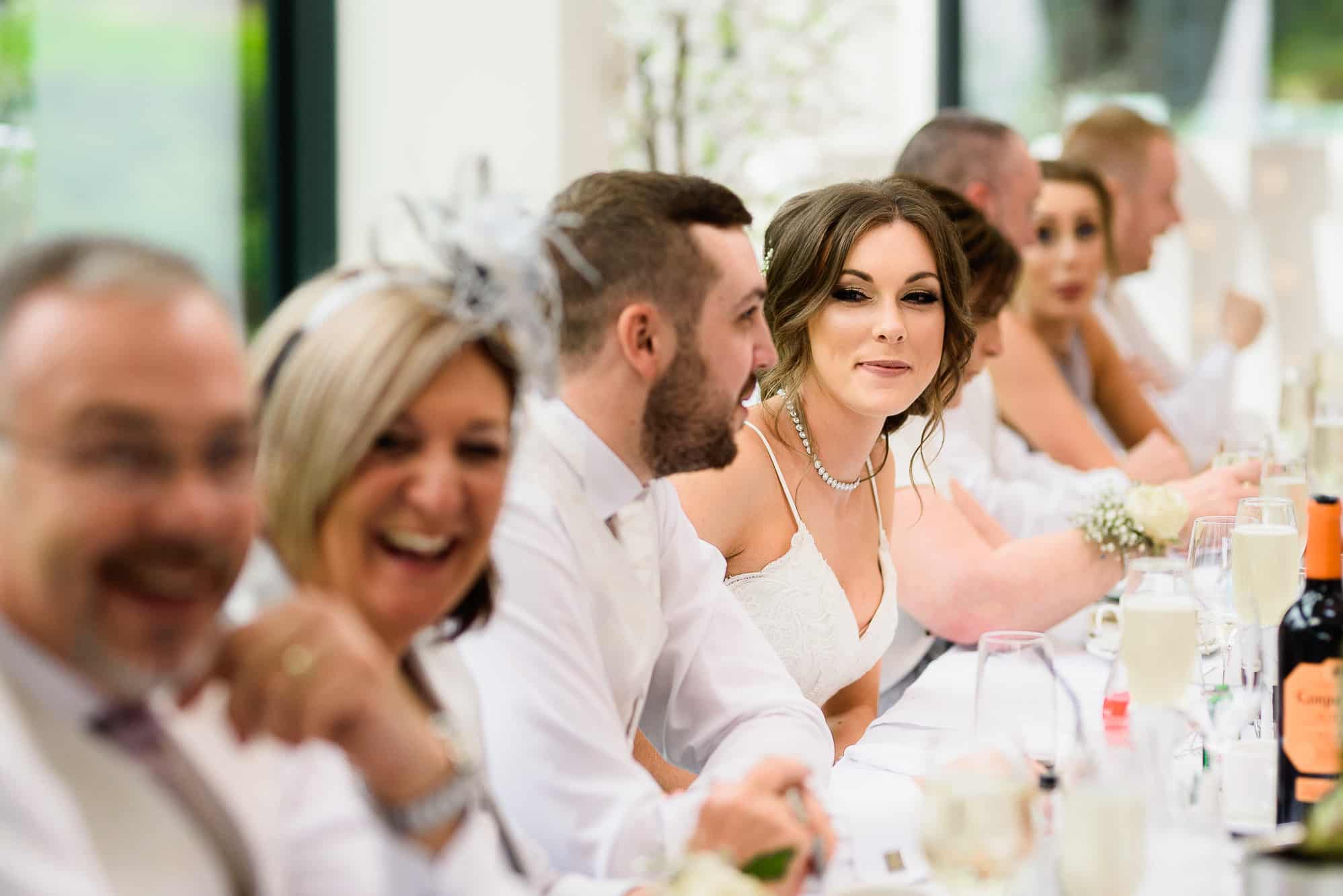 Tyn Dwr Hall Wedding Photography | Andy Griffiths Photography 33 Top table laughing at Tyn Dwr Hall