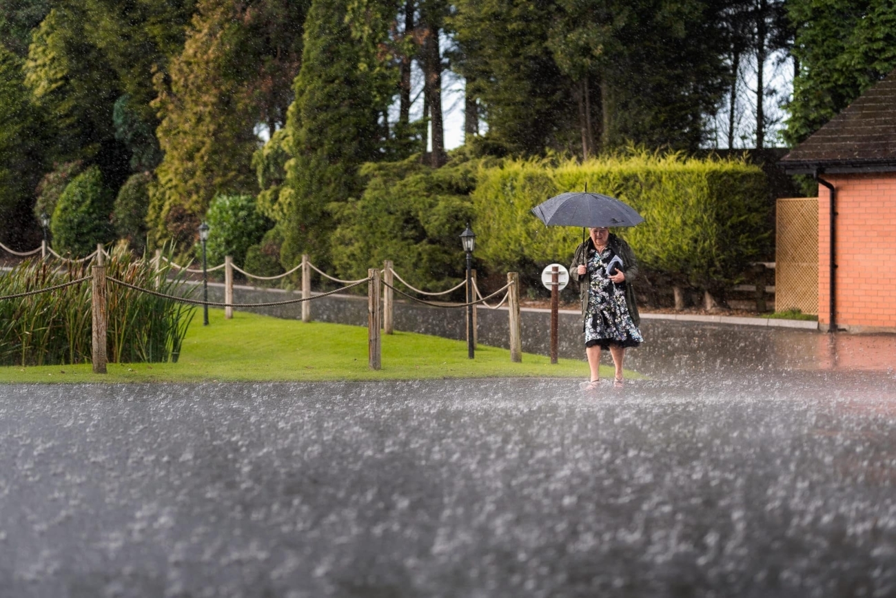 Wedding Photos in the Rain 3 Mother of bride walking in rain at Colshaw Hall