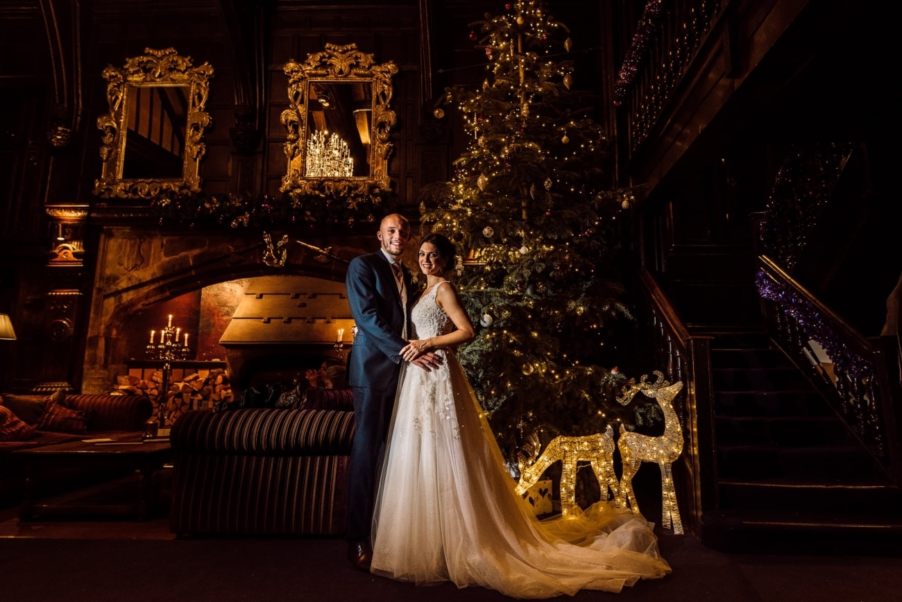 Bride and groom at Mitton Hall in front of the Christmas tree