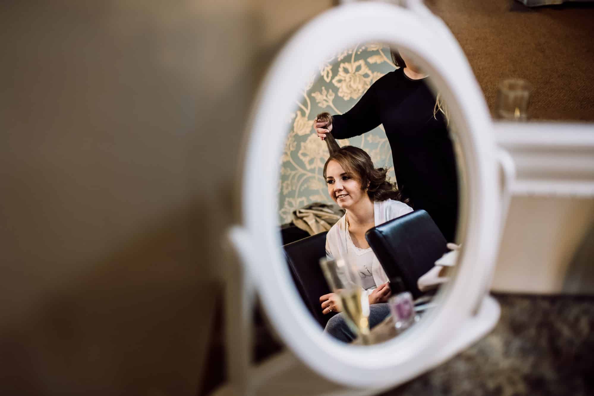 Winter Wedding Photography at Heaton House Farm 3 A photo of the bride in a mirror at hEATON hOUSE fARM