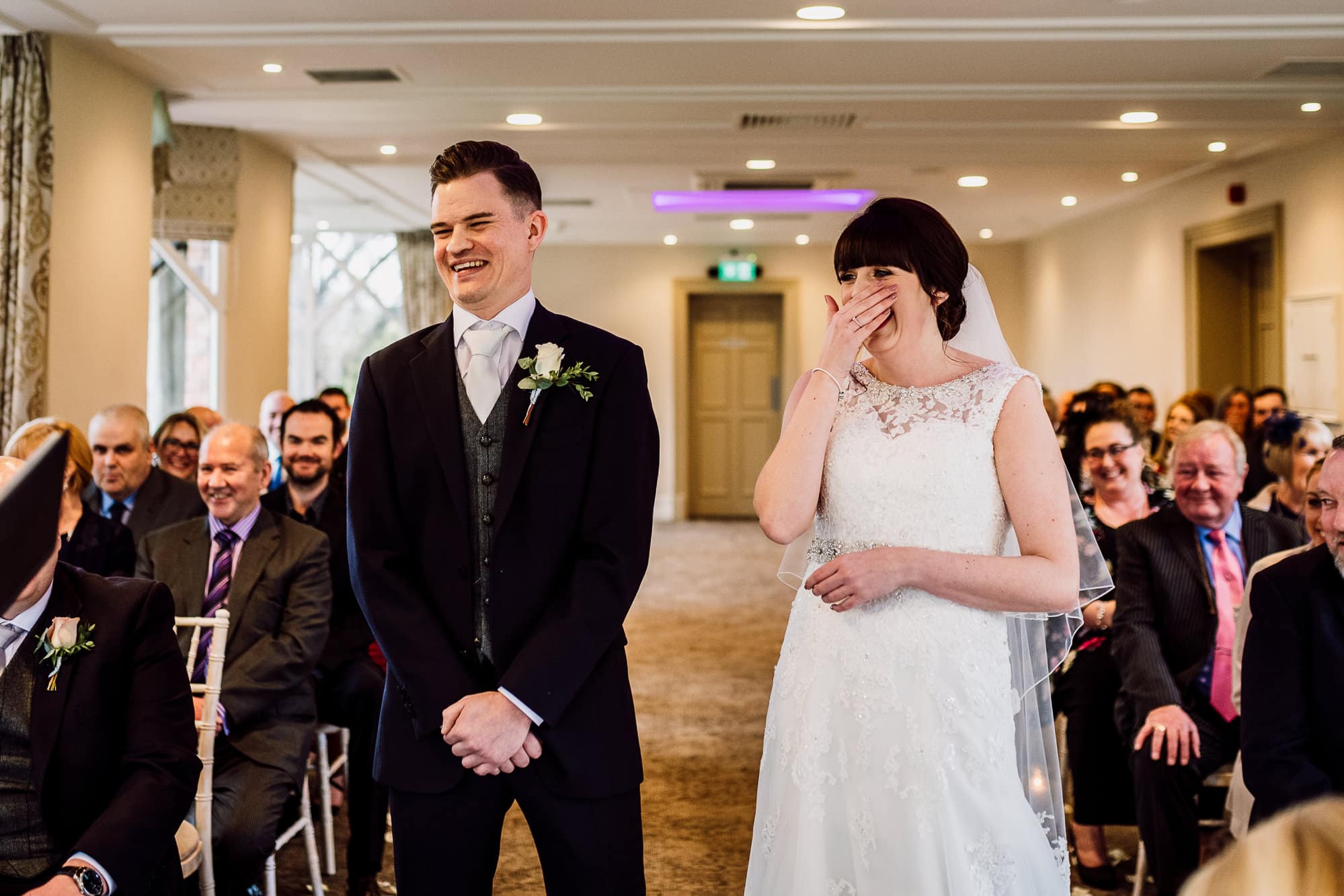 Crabwall Manor Wedding Photography | Mark & Beth 11 The bride is laughing during the service