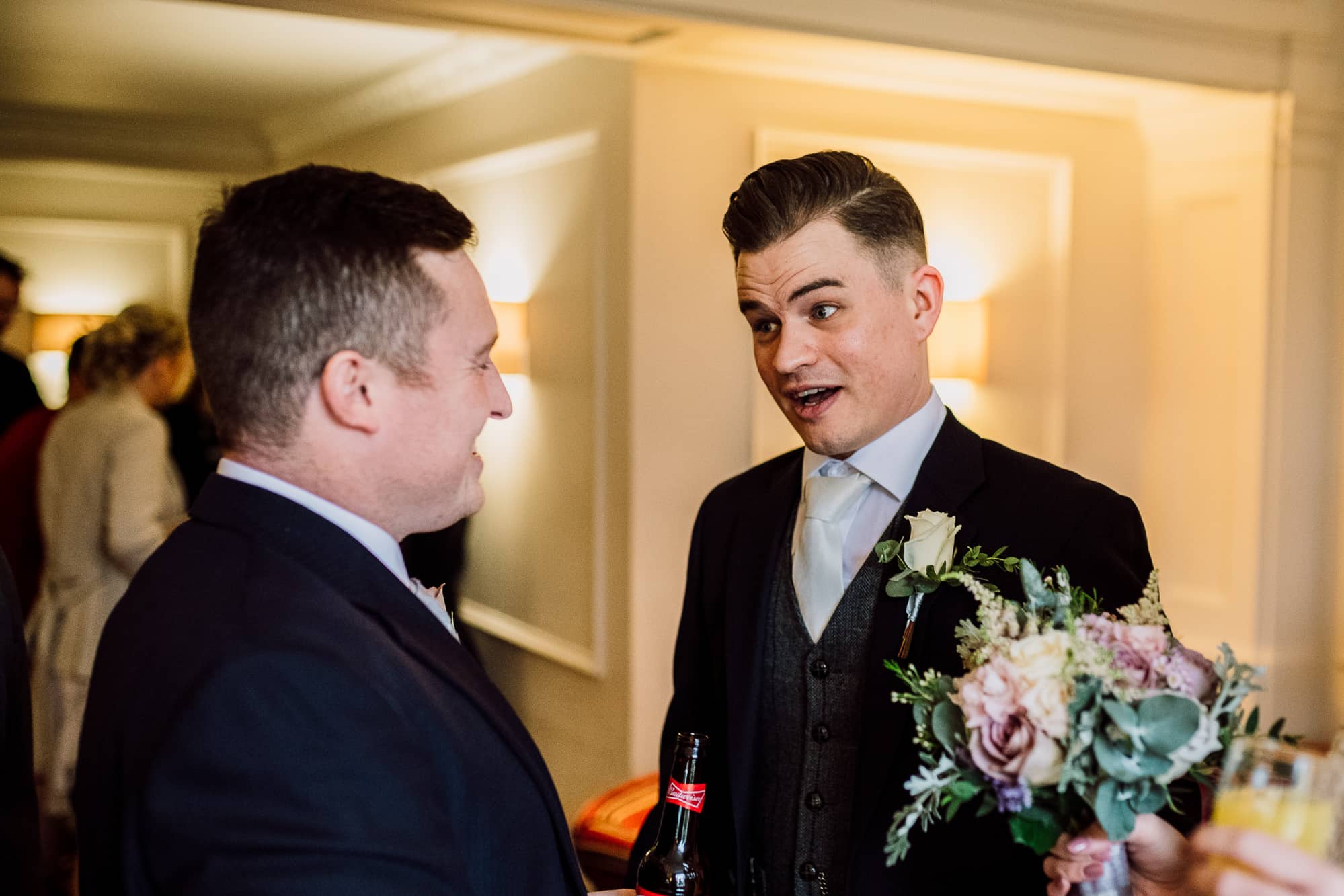 Crabwall Manor Wedding Photography | Mark & Beth 15 Groom is talking to his usher during reception drinks