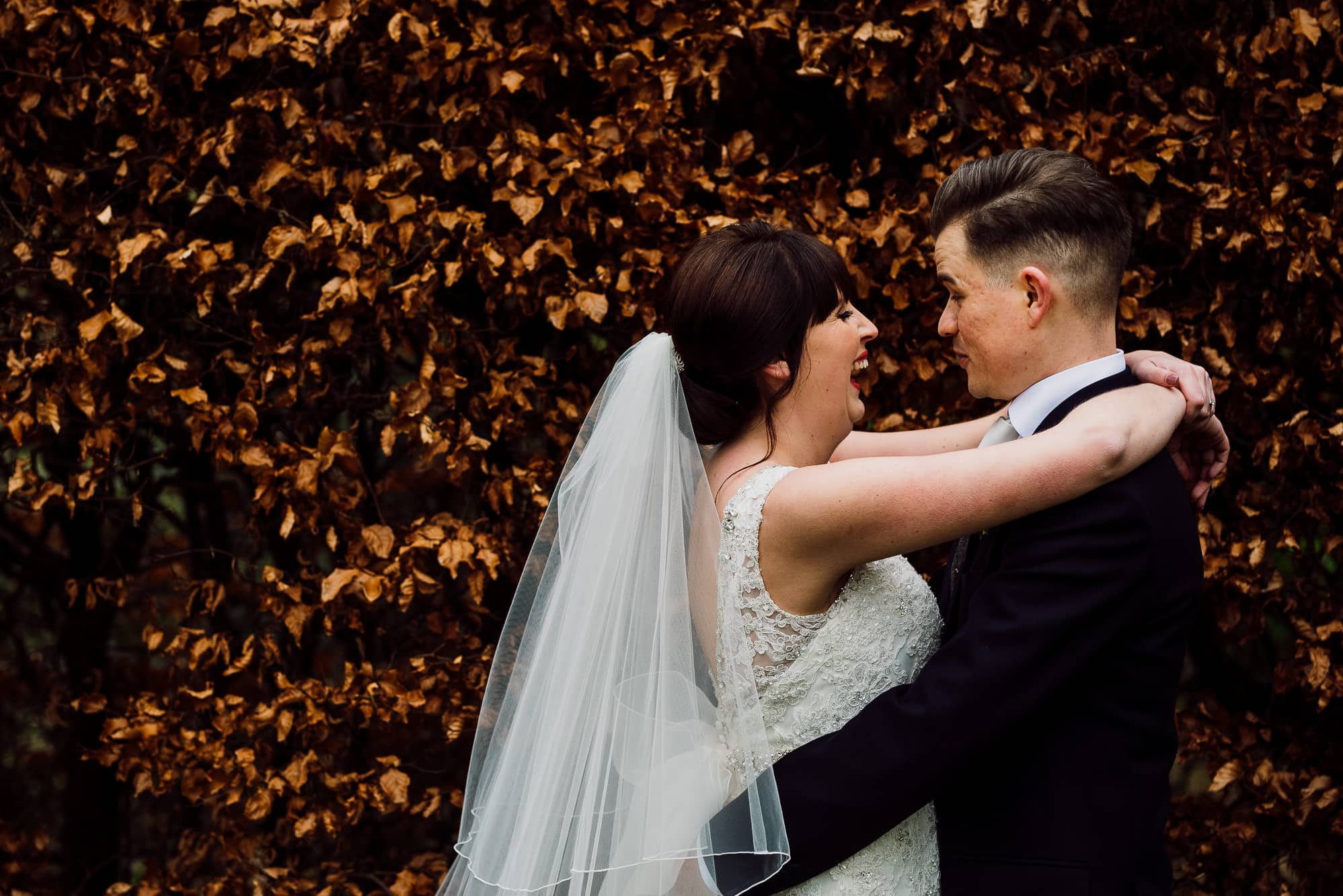 Crabwall Manor Wedding Photography | Mark & Beth 18 Couple hugging infront of some coloured leaves