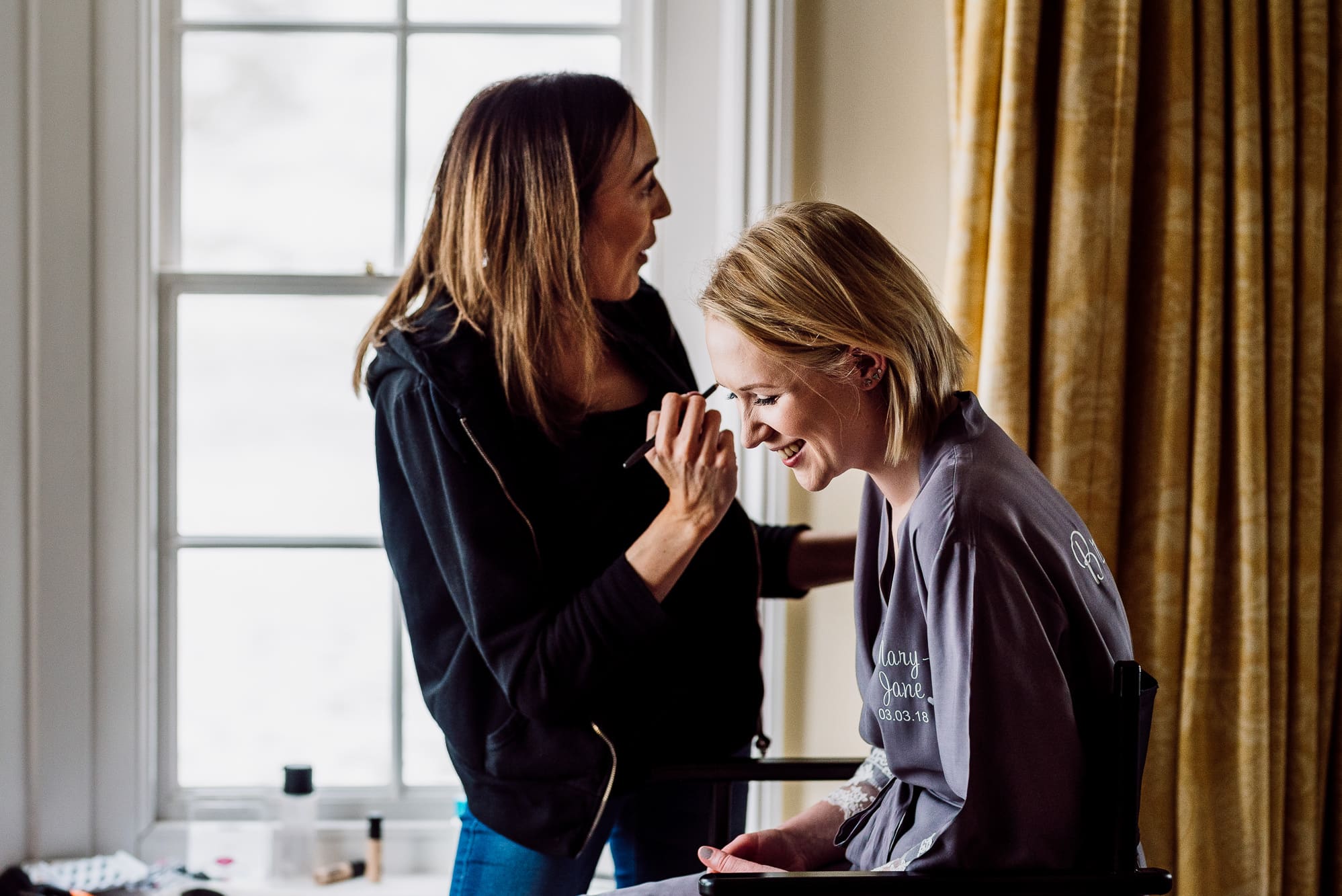 A bridesmaid having her make up done by Luciemua at the Inn at Whitewell