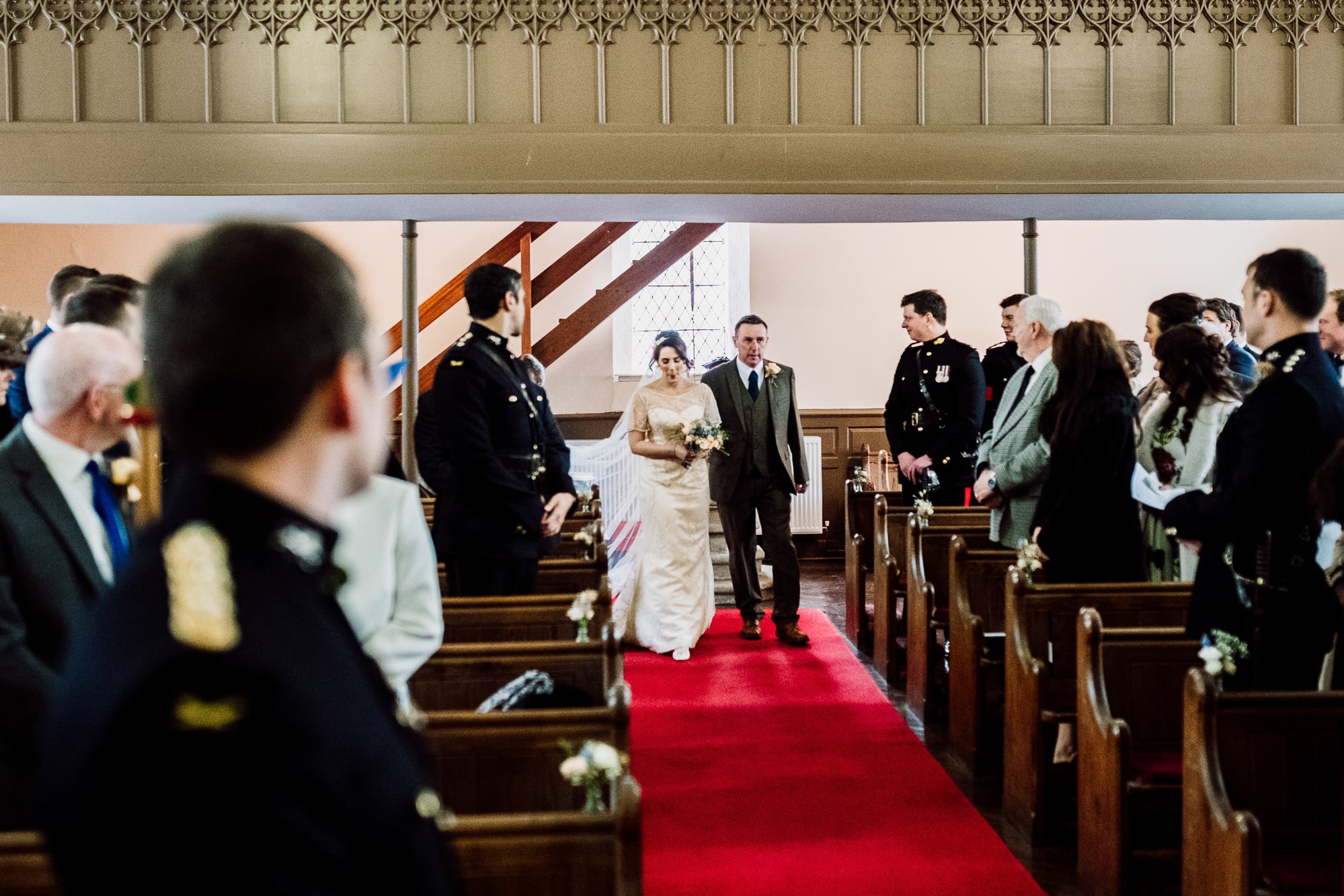 The bride walking down the aisle with her dad