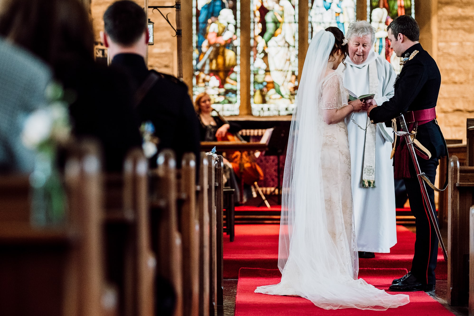 A photo from behind of the bride and groom getting married
