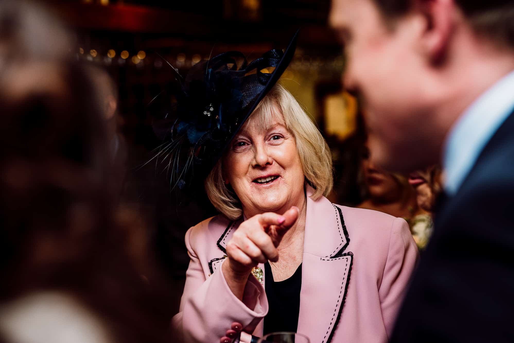 Mother of the bride laughing during reception drinks at the Inn at Whitewell