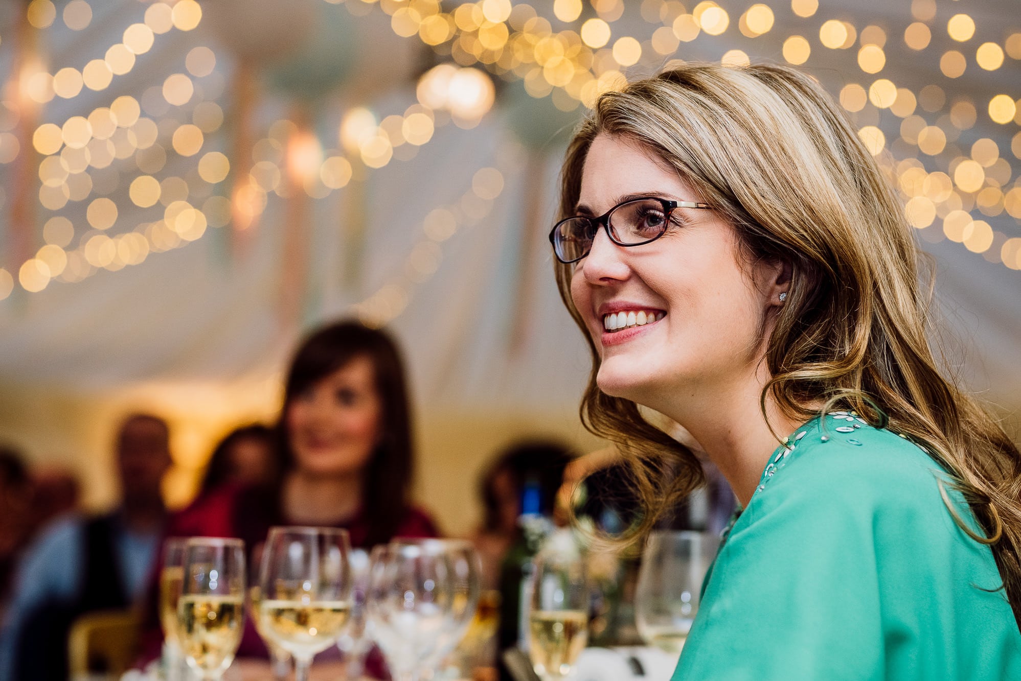 A wedding guest laughing