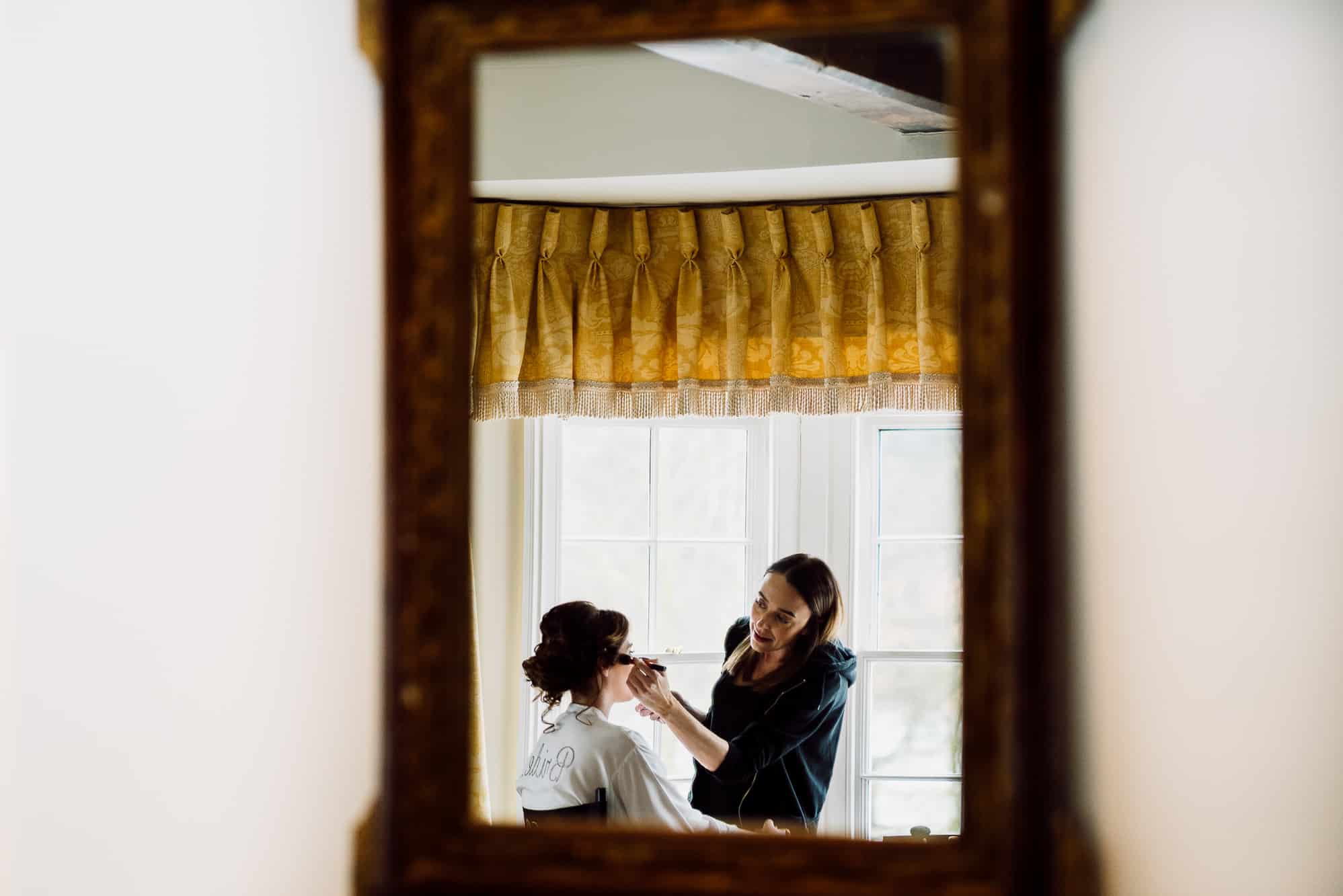 A reflection of make up being applied at the Inn at Whitewell