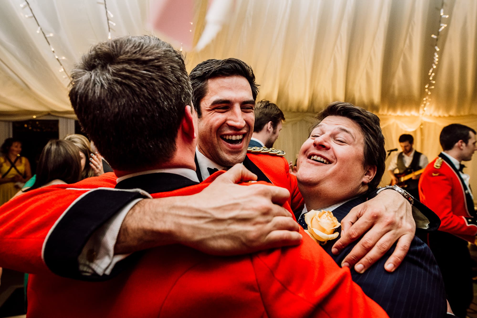Guests laughing and hugging on the dance floor