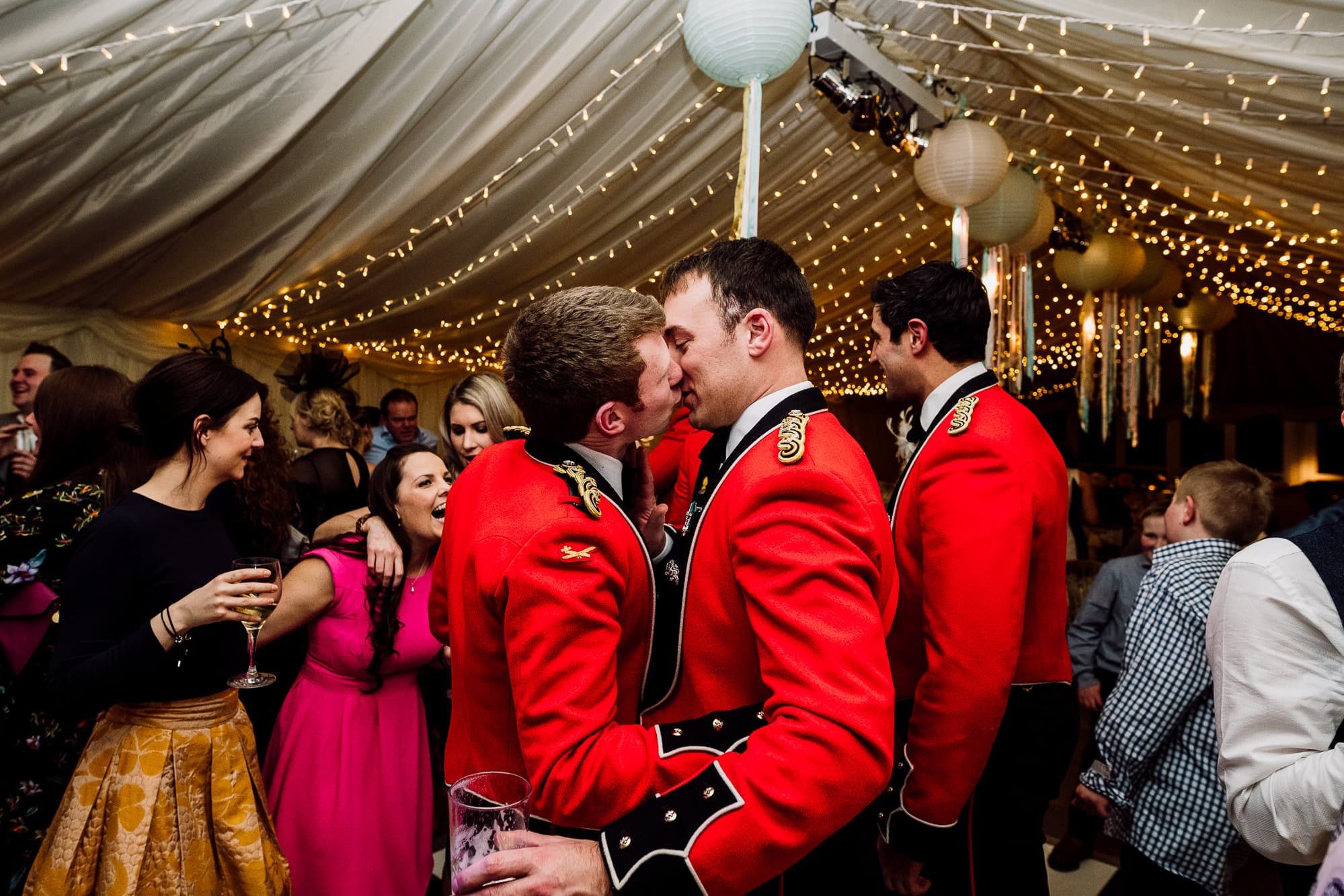 Two men kissing on the dance floor