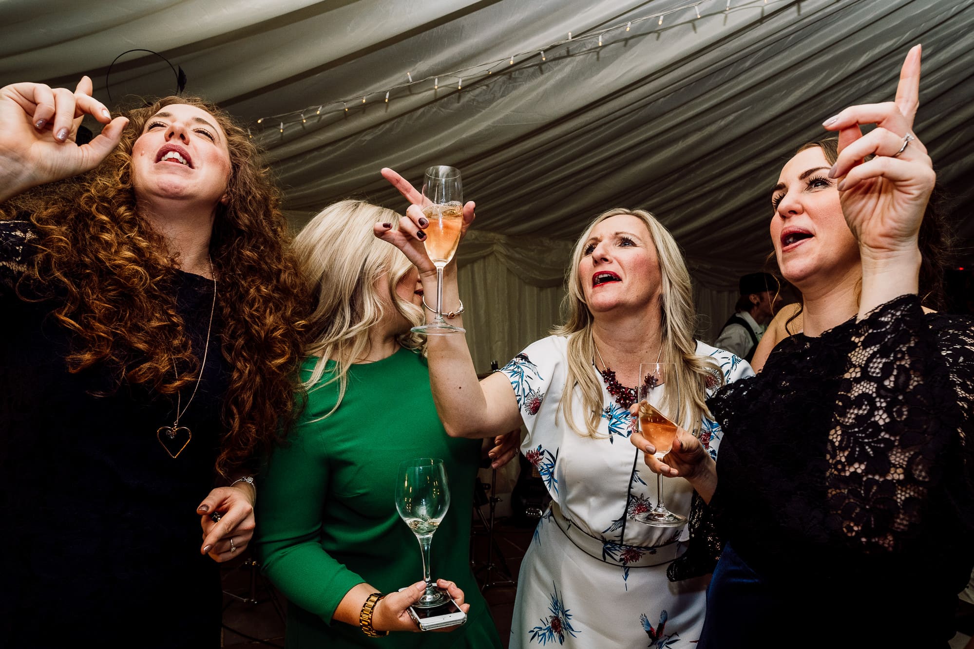 A group of female guests dancing