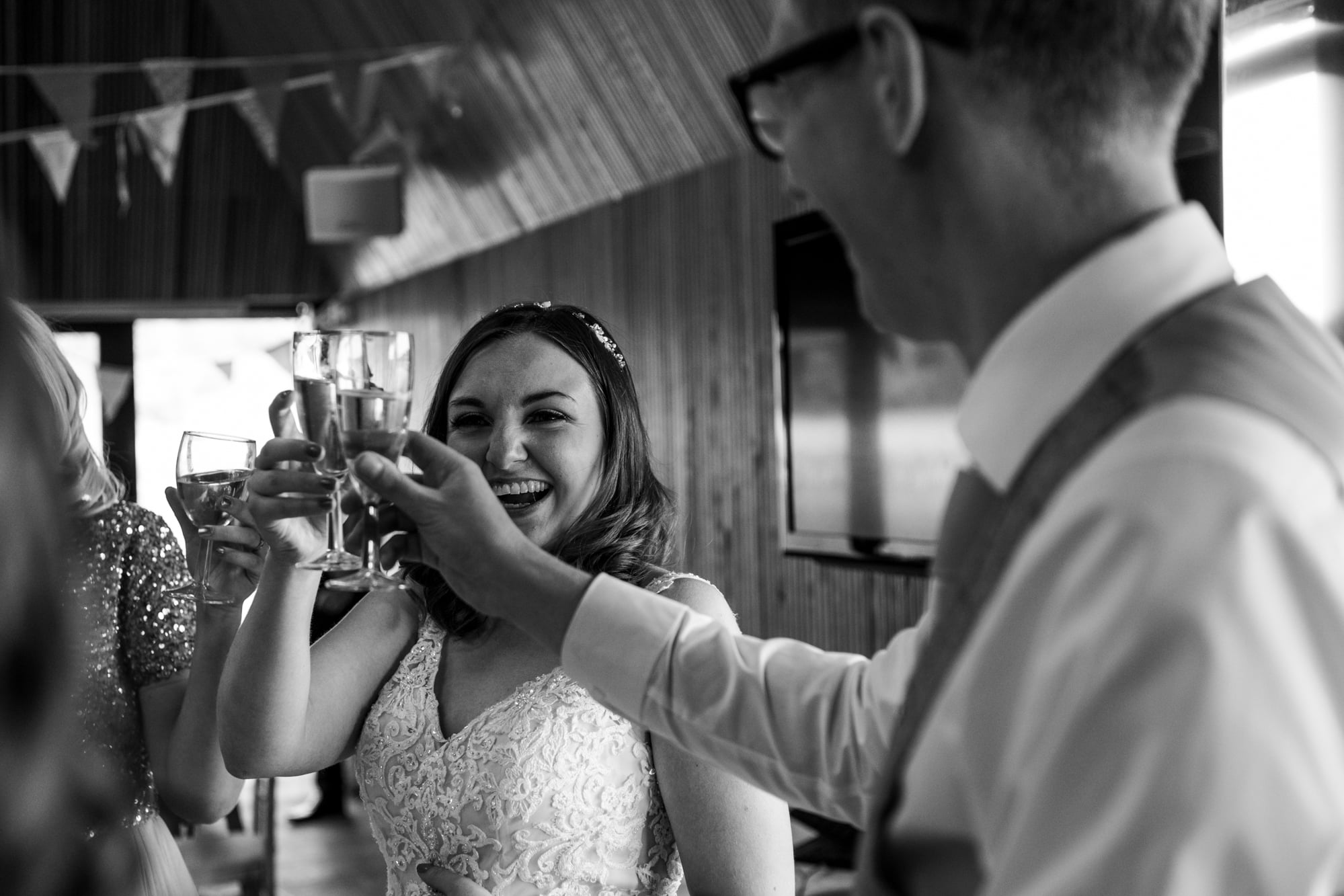 bride and groom raising their glasses