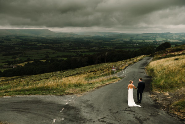 Bride and groom walking looking out to the Ribble Valley