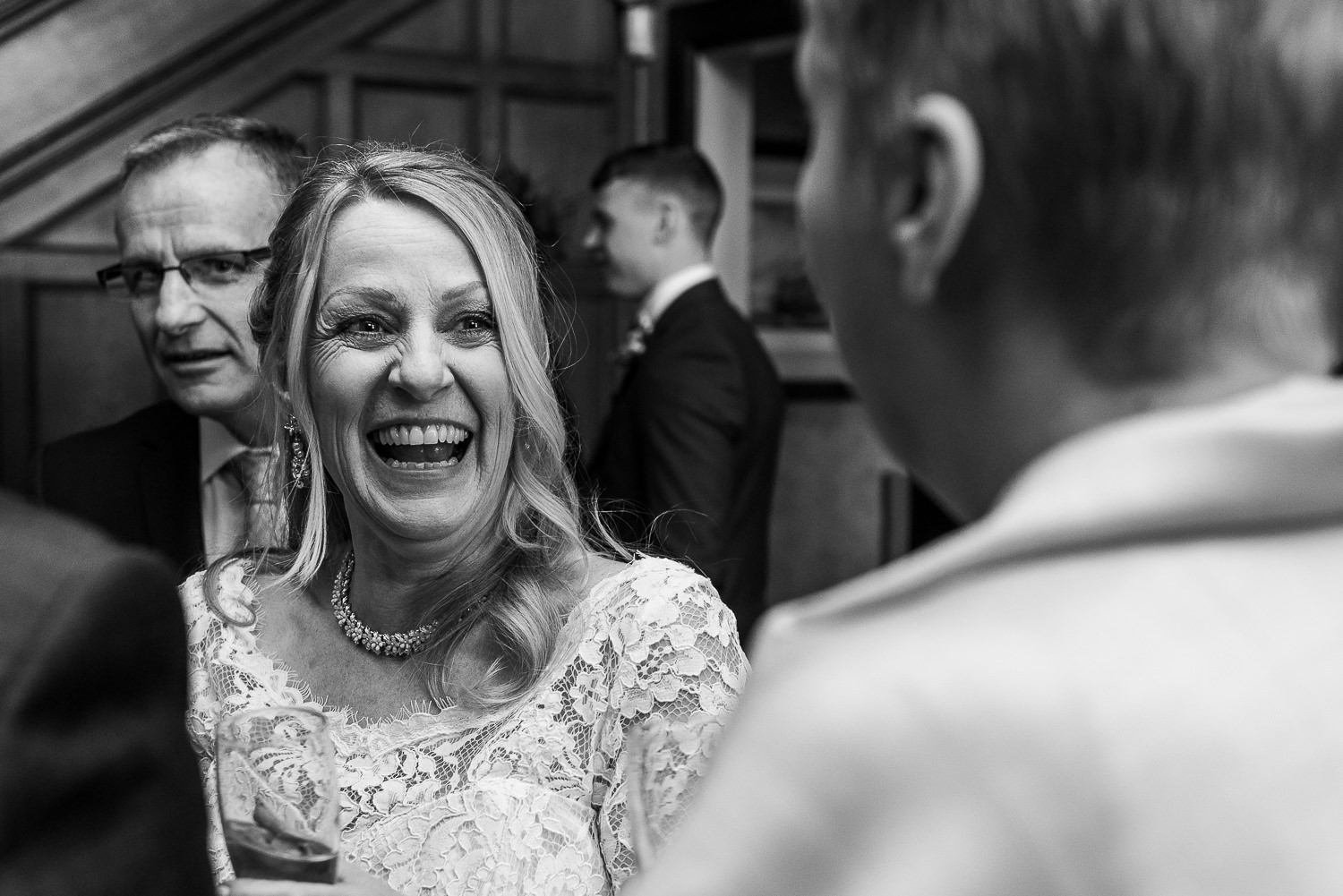 Bride laughing with guests