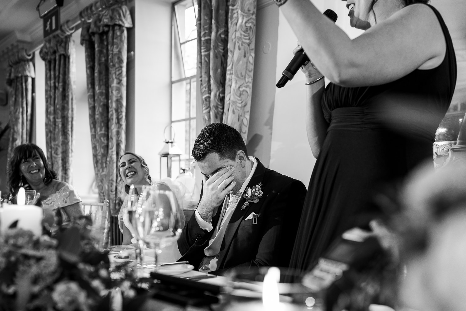 Groom has his head in his hands during speeches