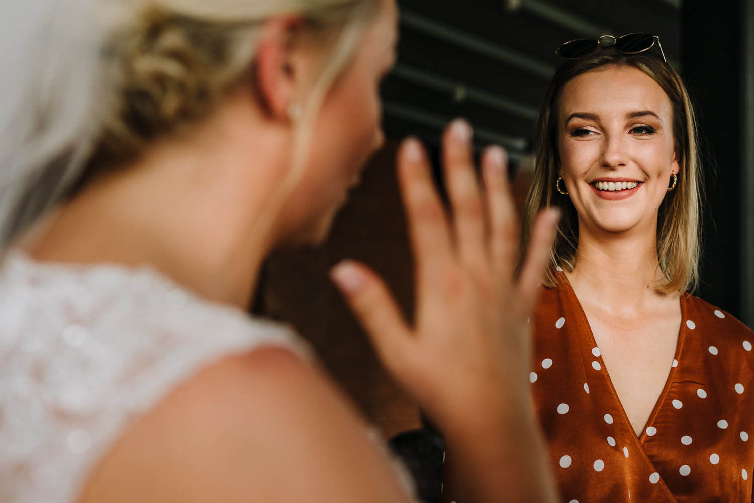 Bride laughing with a female guest