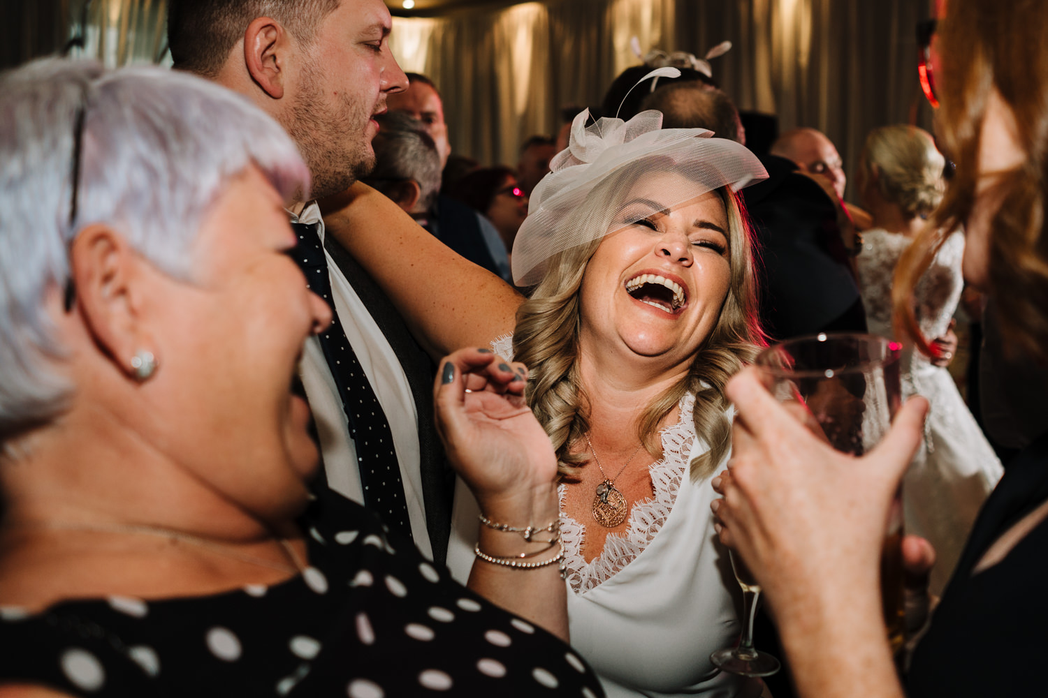 Wedding guests dancing and laughing