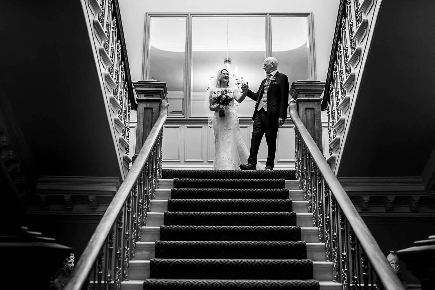 Bride and her dad walking down the stairs at Ashfield house