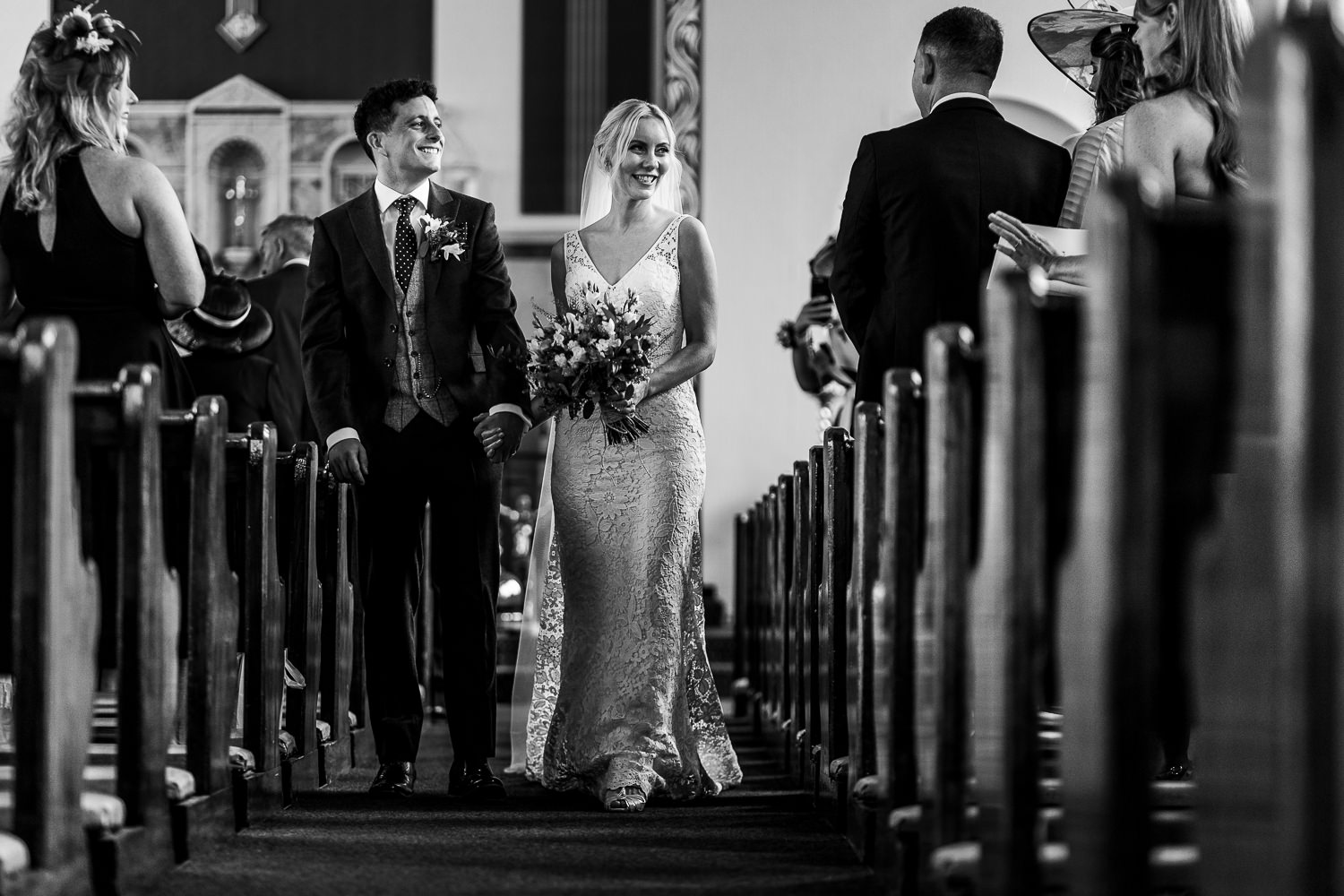 Bride and groom walking out of the church