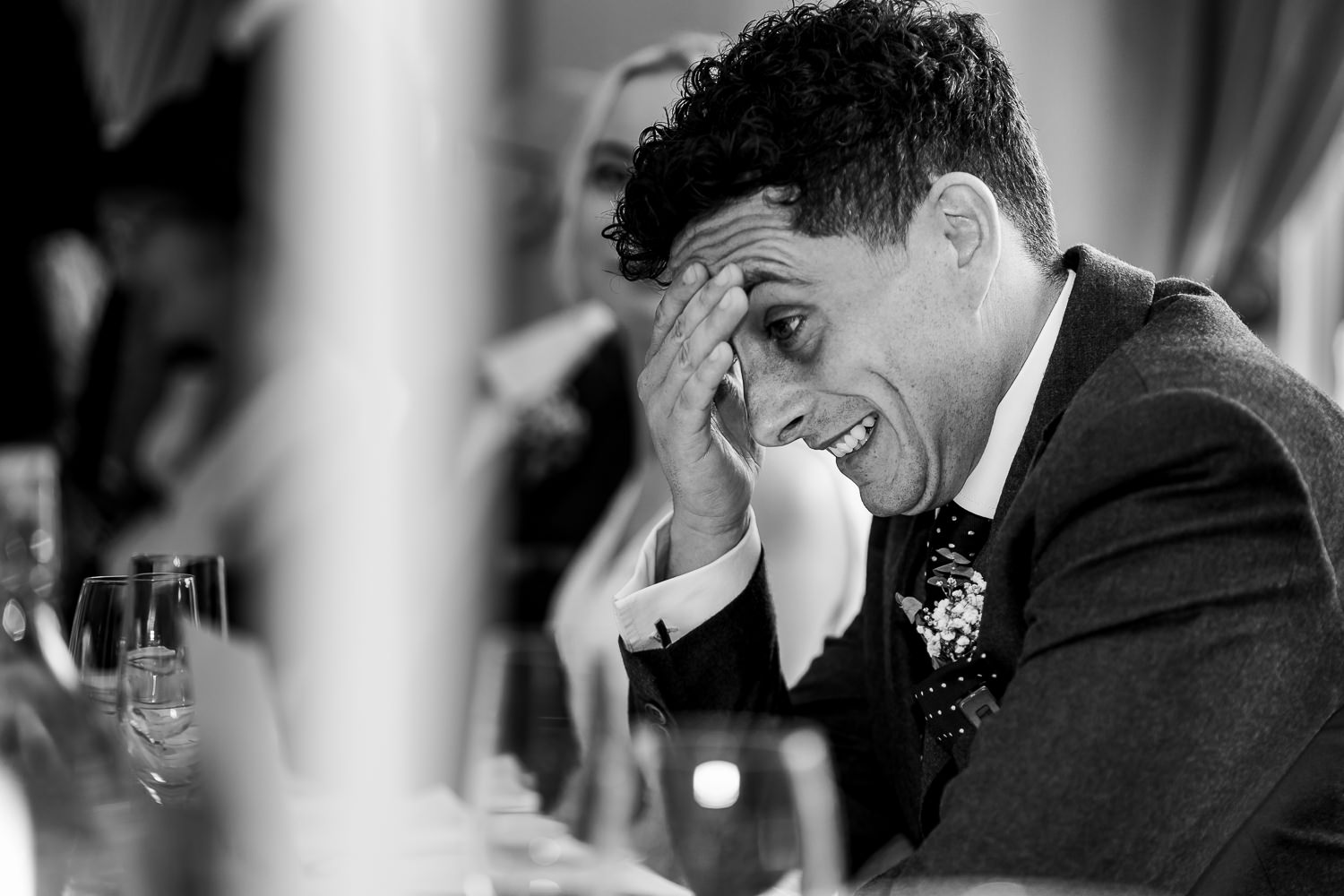 groom laughing during speeches
