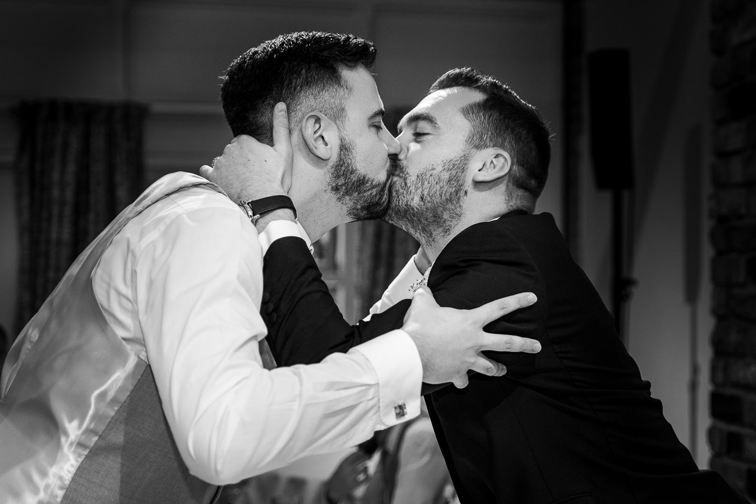groom kissing a male guest