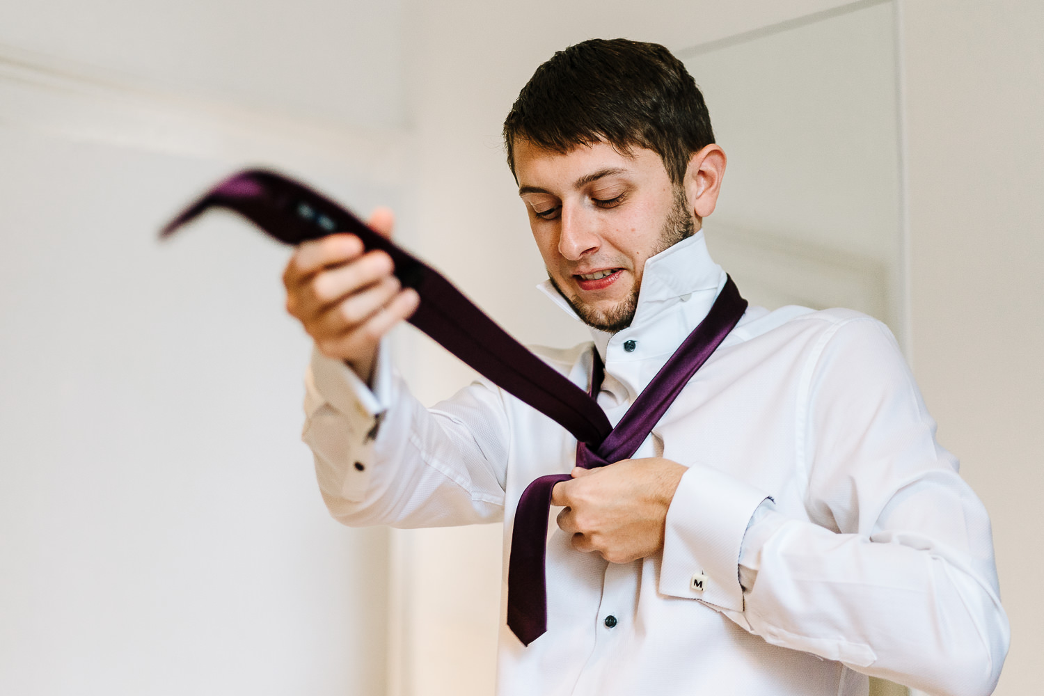 Groom doing his tie in Lancaster before heading to Ashton memorial