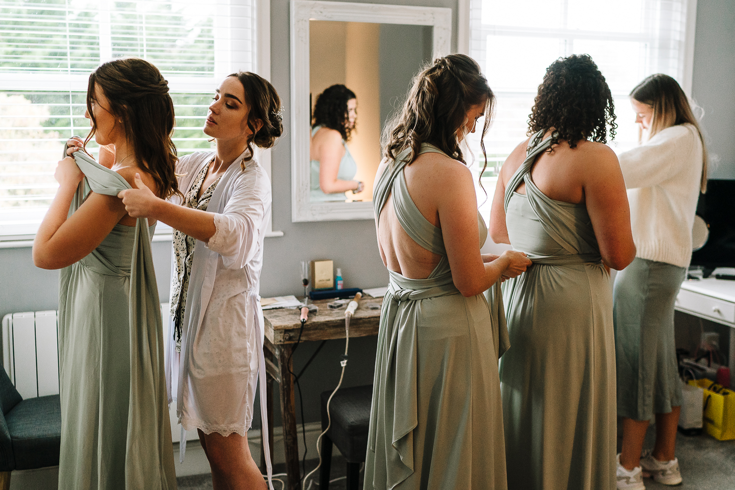 bride and bridesmaids getting dressed