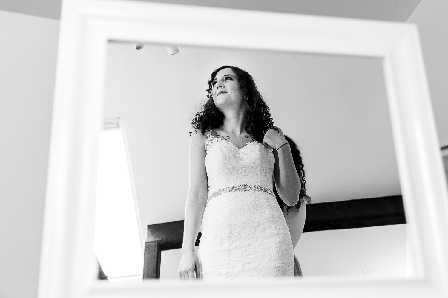 bride getting ready in the mirror