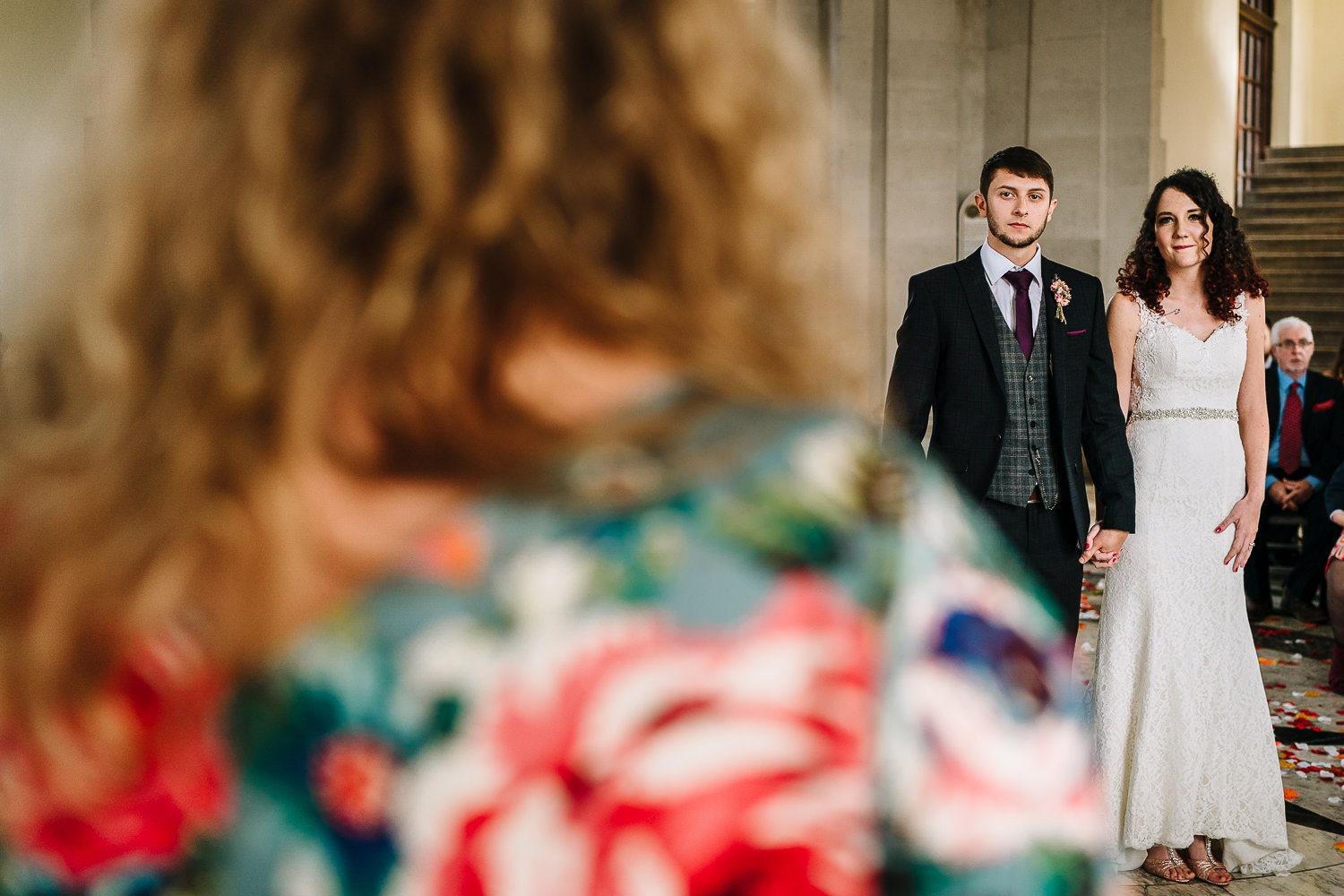 bride and groom watching a reading