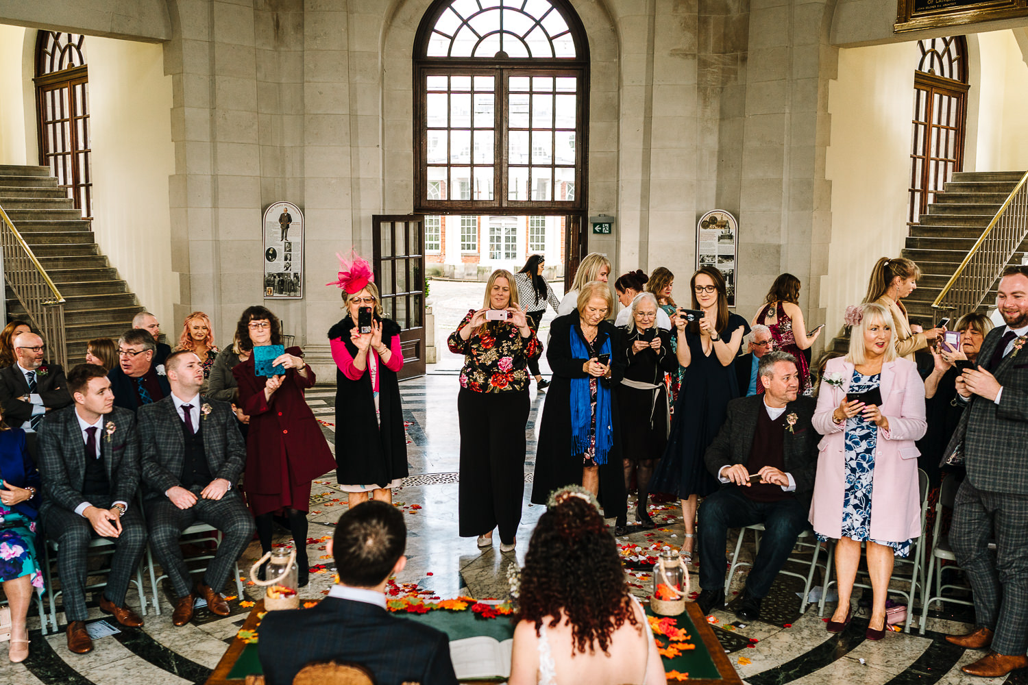 Bride and groom having photos of the signing of the register