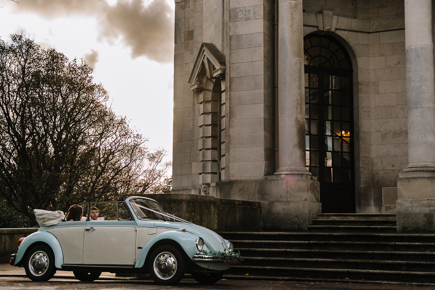 bride and groom leaving Ashton Memorial